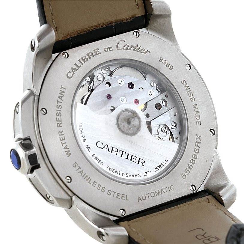 The image shows the back view of a Calibre de Cartier watch by Cartier, showcasing its automatic movement through a transparent case back.