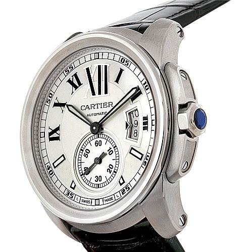The image shows a Calibre de Cartier watch by Cartier from a front-right angle, highlighting the dial, crown, and part of the strap.