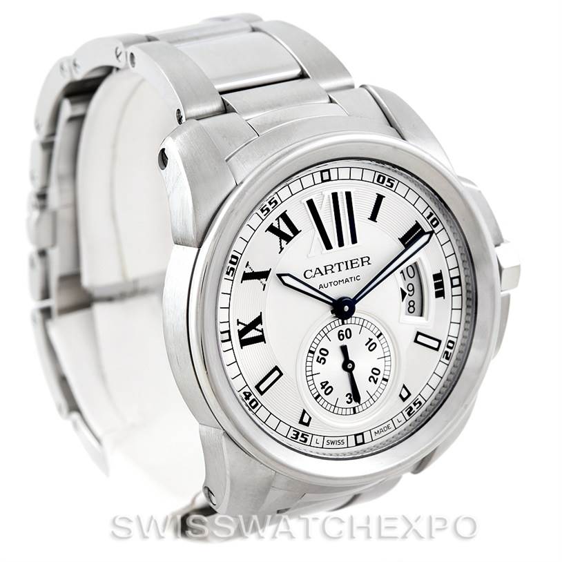 The Calibre de Cartier watch is shown at an angled side view, highlighting the stainless steel case, bracelet, dial, and Roman numeral markers.