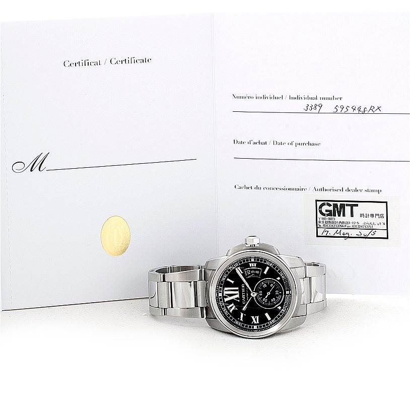 The image shows a front view of a Calibre de Cartier watch by Cartier, placed in front of its certification paperwork.