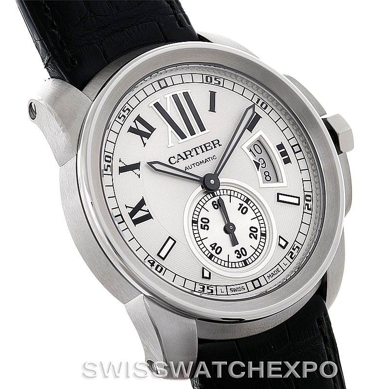 The image shows a Calibre de Cartier watch by Cartier at an angled view, highlighting the dial, hands, and part of the leather strap.