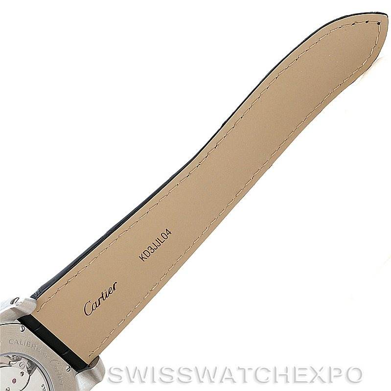 The image shows the underside of the strap and part of the back case of the Calibre de Cartier watch by Cartier.