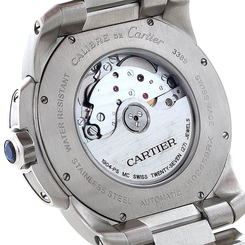 This image shows the back view of a Calibre de Cartier watch by Cartier, revealing its movement and surrounding inscriptions.
