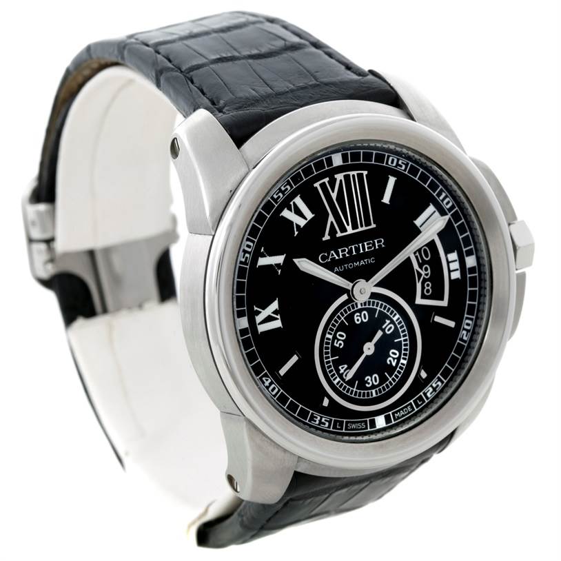 The image shows a Calibre de Cartier watch by Cartier at an angle emphasizing its black dial, Roman numerals, and leather strap.