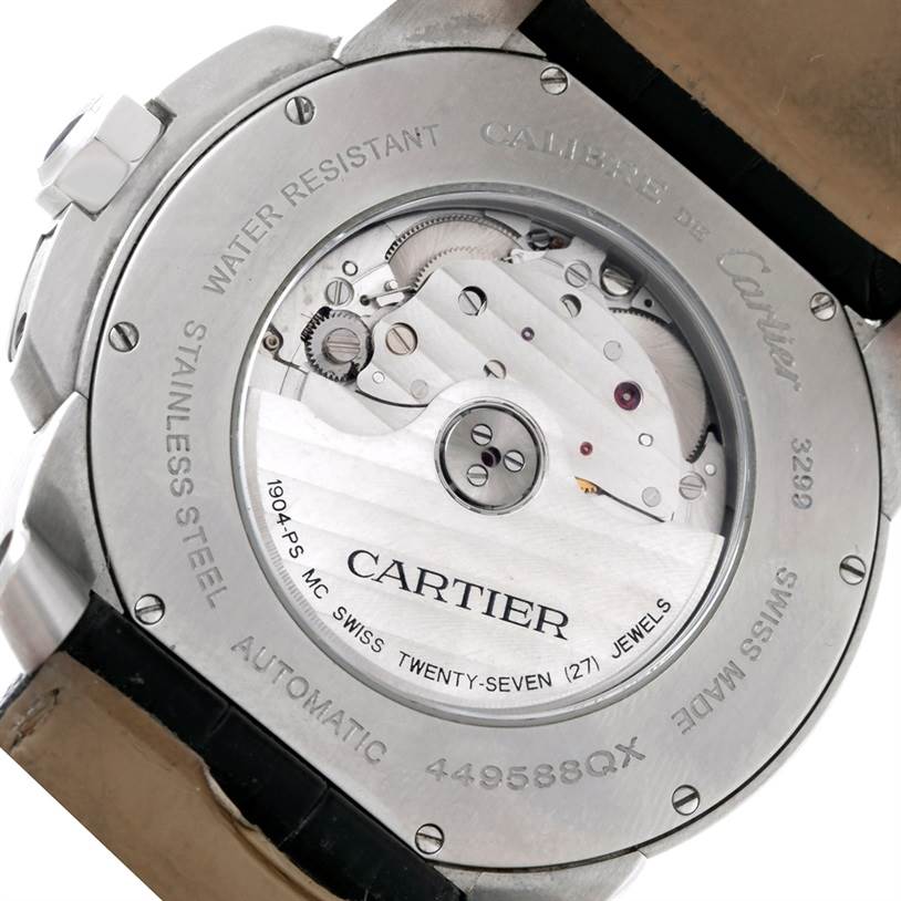 The image shows a close-up view of the back case of a Calibre de Cartier watch by Cartier, highlighting its automatic movement and internal mechanics.