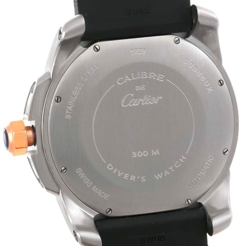 The image shows the back case and part of the strap of the Calibre de Cartier watch by Cartier.