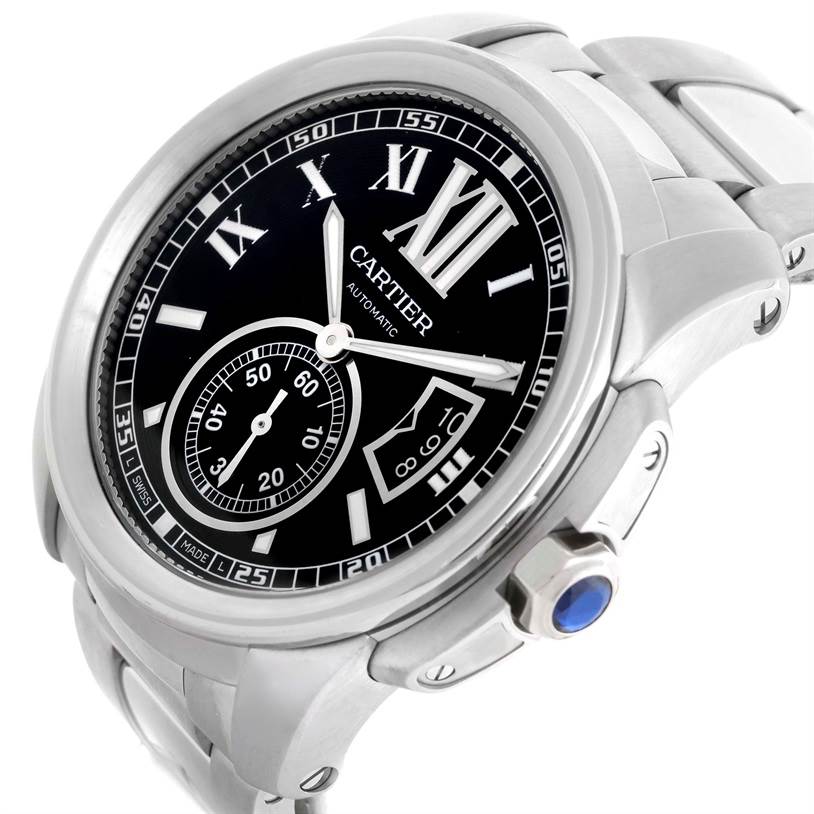 The Calibre de Cartier watch is shown at a tilted angle featuring its black dial, Roman numerals, and a steel bracelet.