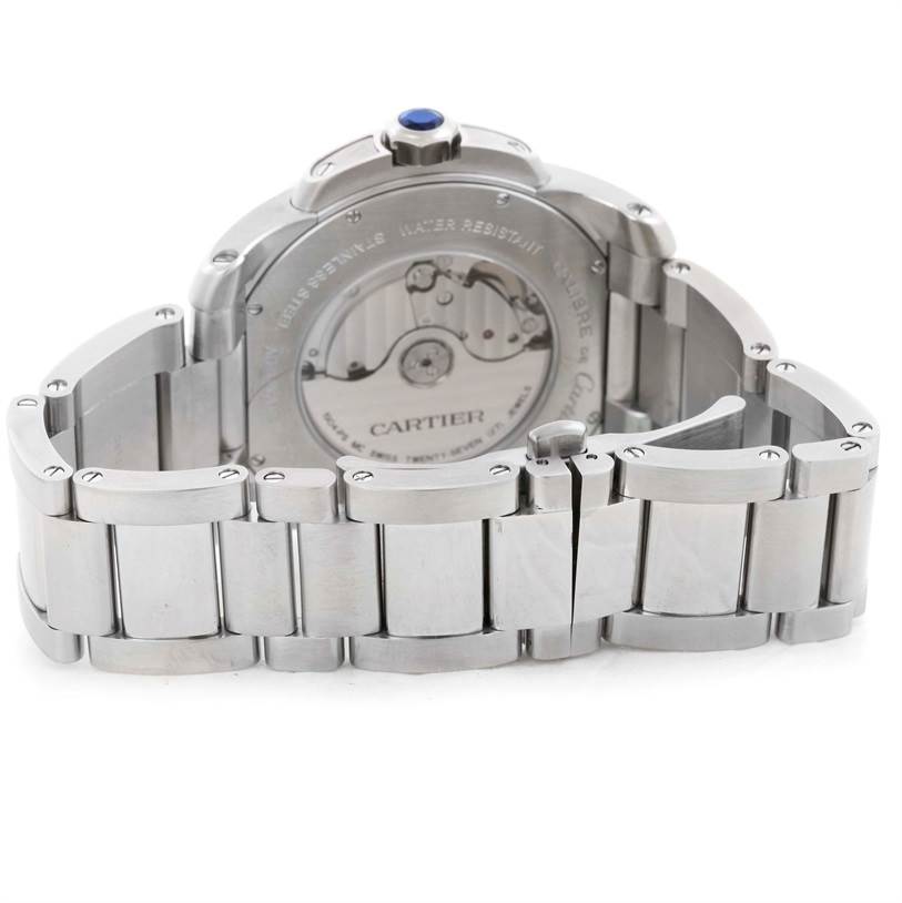 This image shows the back of the Calibre de Cartier watch by Cartier at an angle, highlighting its bracelet and mechanical movement.