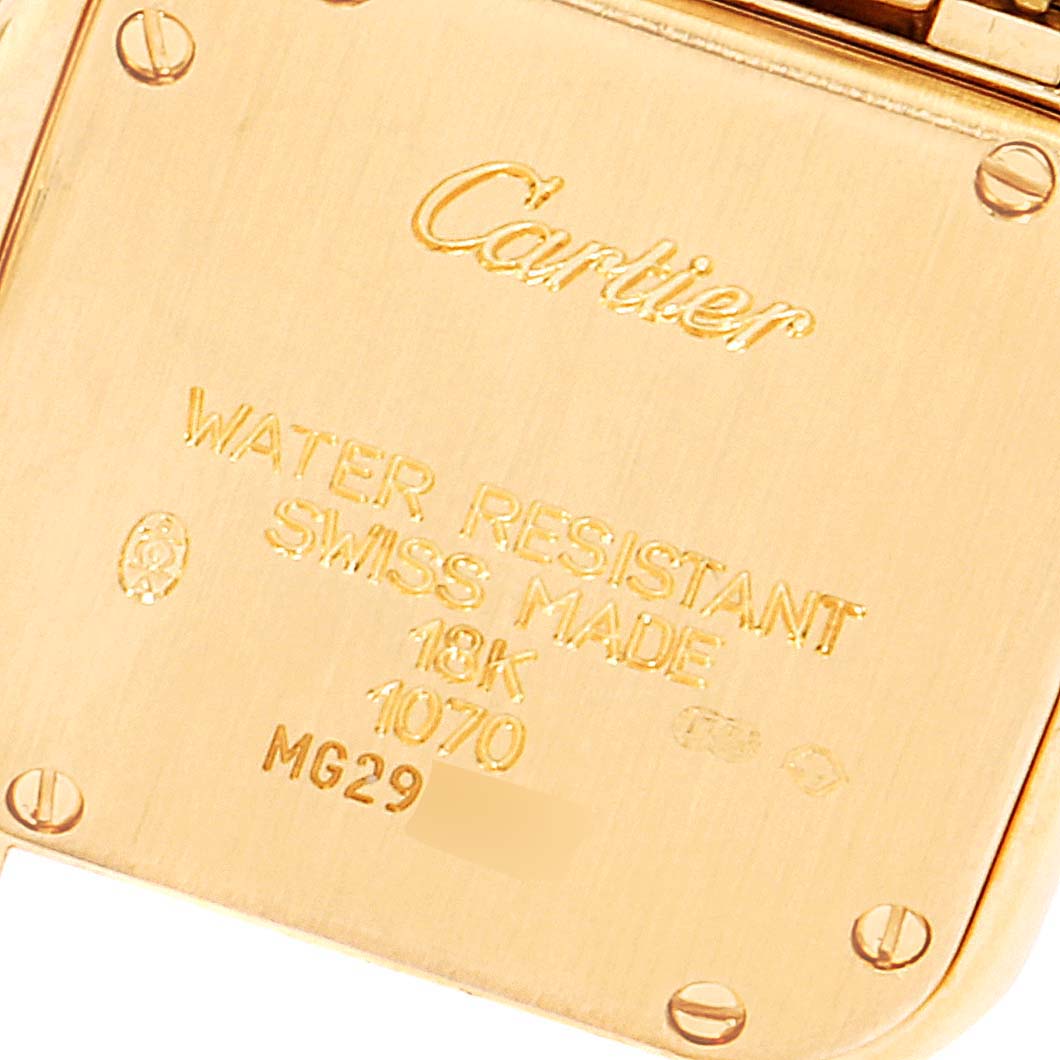 This close-up image shows the back case of a Panthère model watch by Cartier, displaying its engravings and screws.