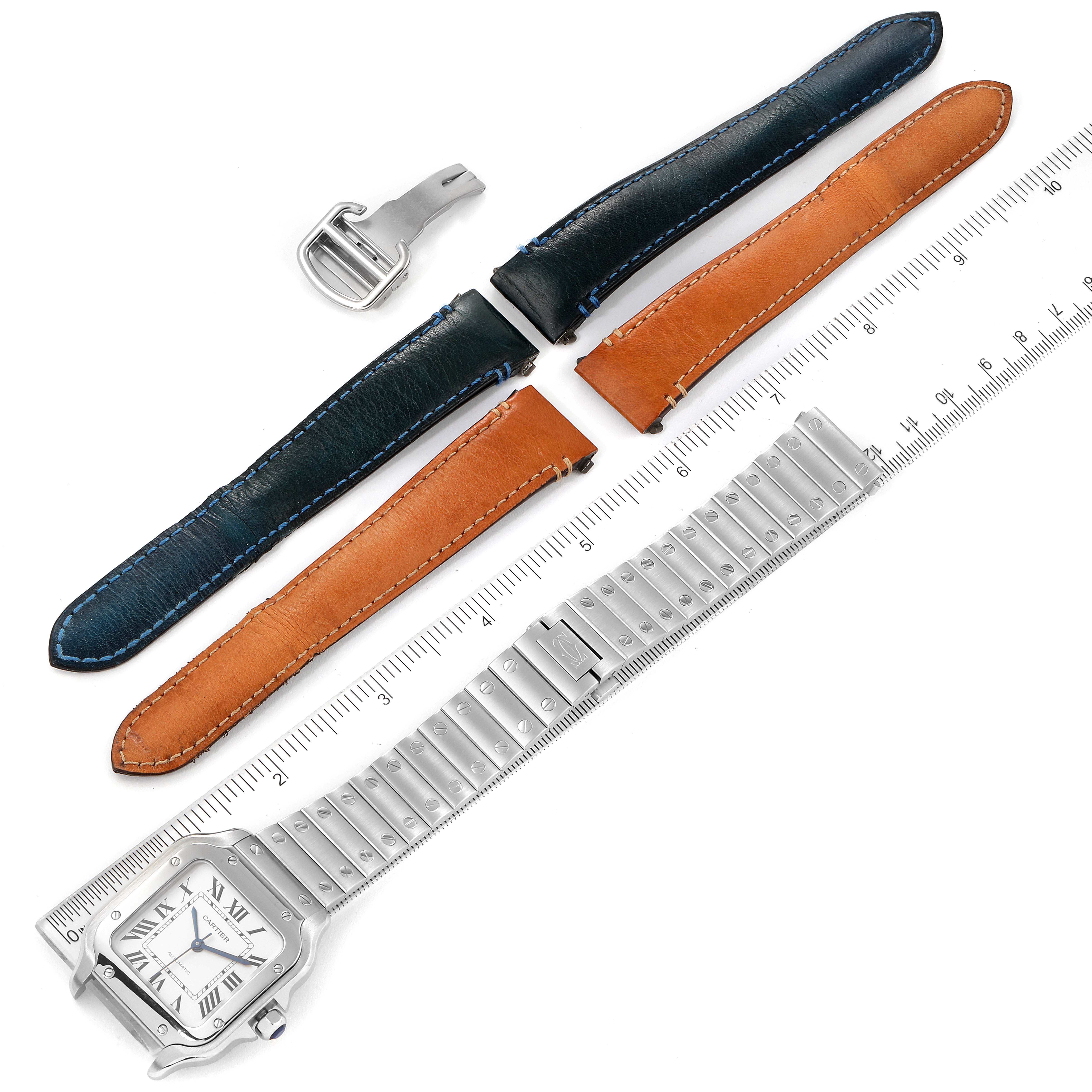 The image shows a Cartier Santos WSSA0010 Men's Stainless Steel Silver Dial WSSA0010 Men's Stainless Steel Silver Dial watch with metal and leather straps, a buckle, and a ruler for size reference.