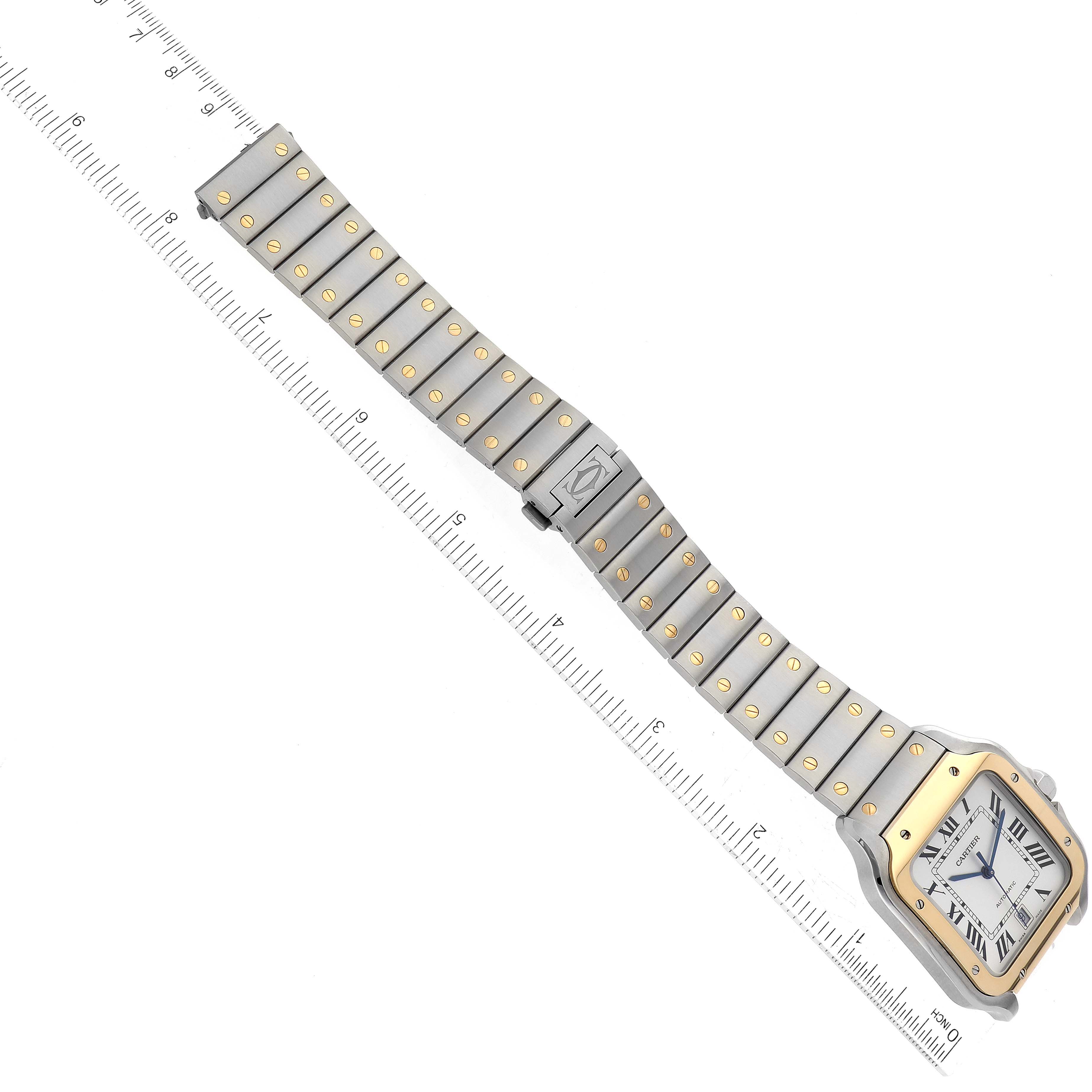 The image shows a top view of the Cartier Santos W2SA0009 Men
s Stainless Steel Silver Dial W2SA0009 Men
s Stainless Steel Silver Dial watch, emphasizing its face, strap, and a ruler for scale.