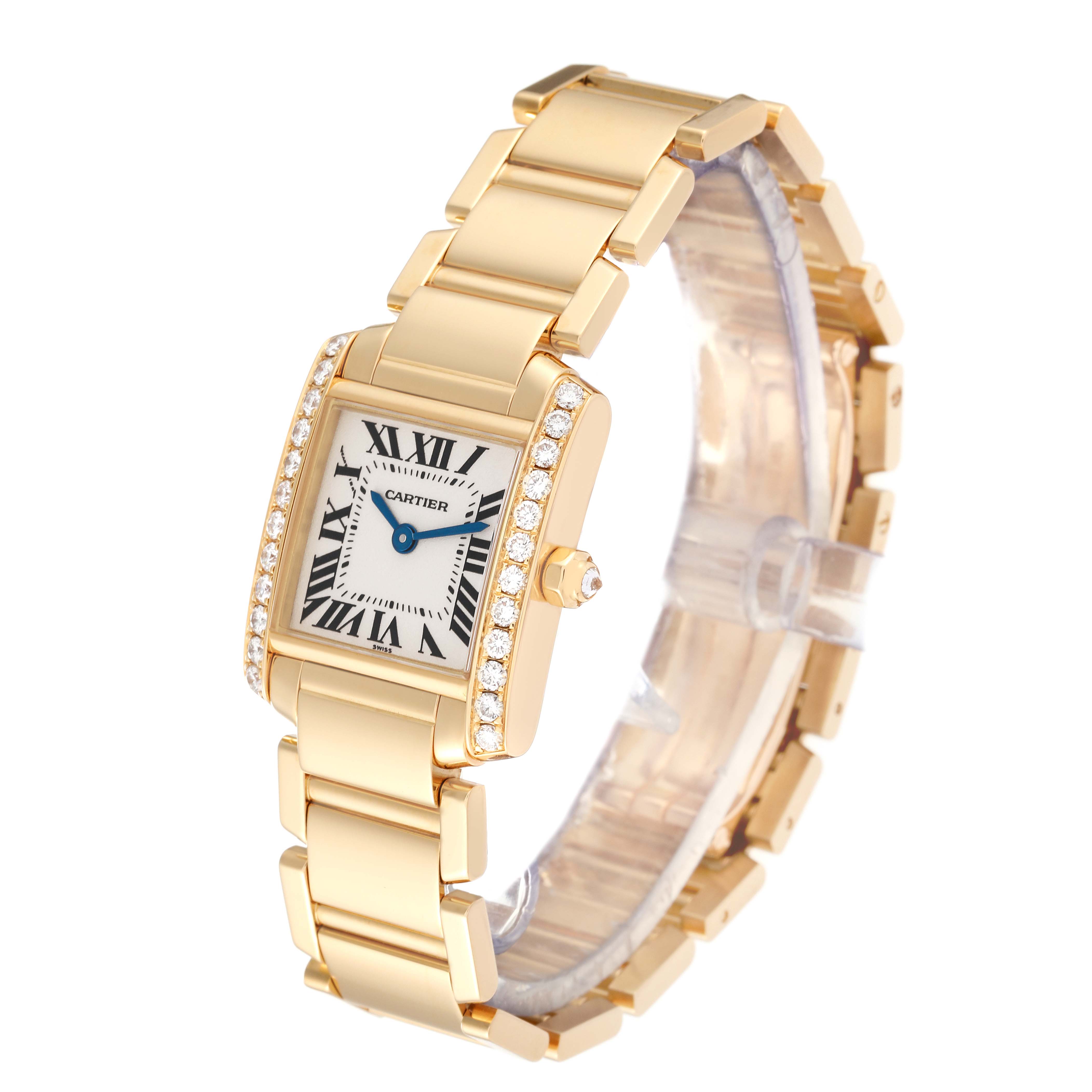 The image shows a Cartier Tank Francaise WE1001R8 Women's Yellow Gold Silver Dial WE1001R8 Women's Yellow Gold Silver Dial watch angled to display its gold bracelet, rectangular face, and diamond-set bezel.