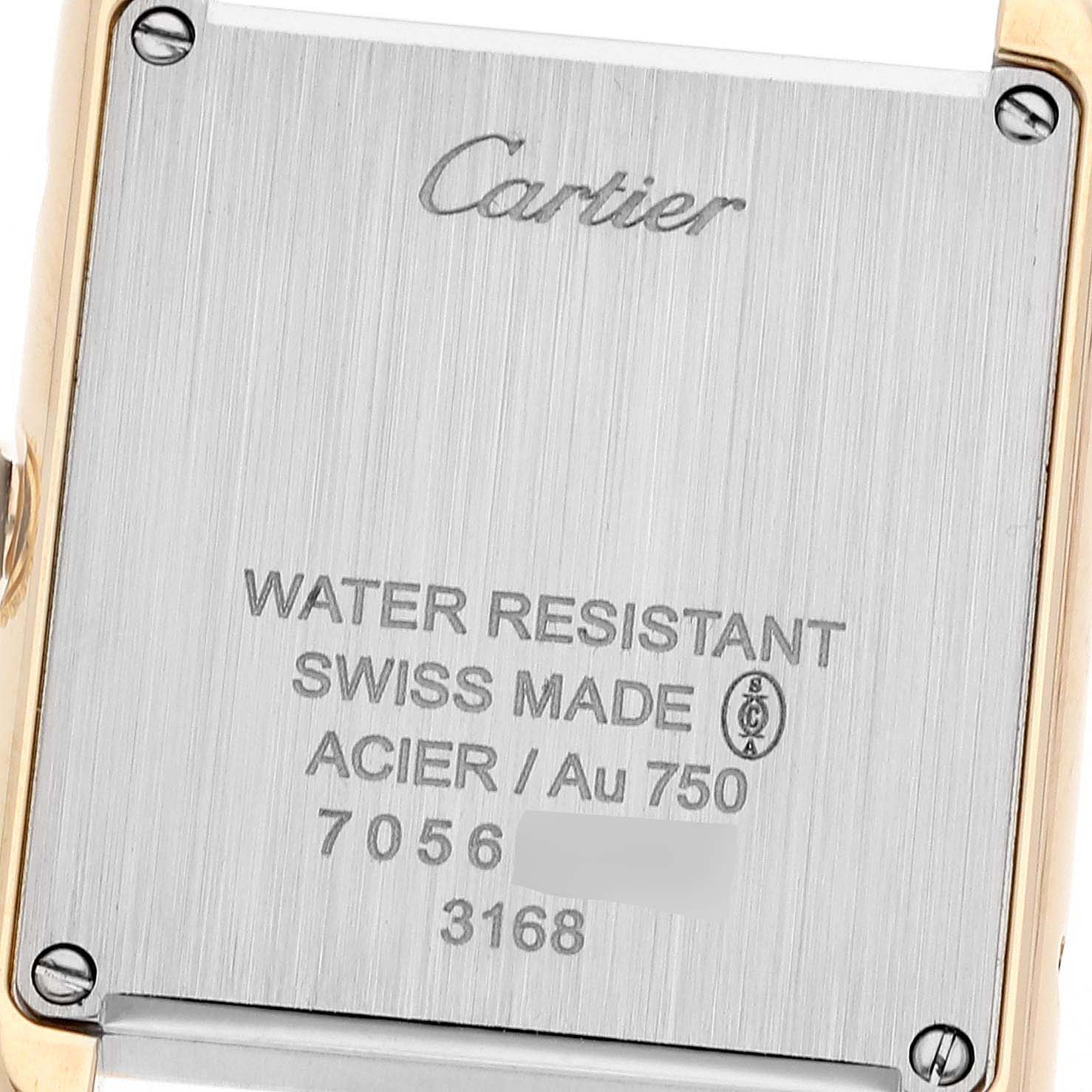 The image shows the back case of a Cartier Tank Solo W5200002 Women
s Steel and Gold (two tone) Silver Dial W5200002 Women
s Steel and Gold (two tone) Silver Dial watch, highlighting its engravings and screws.