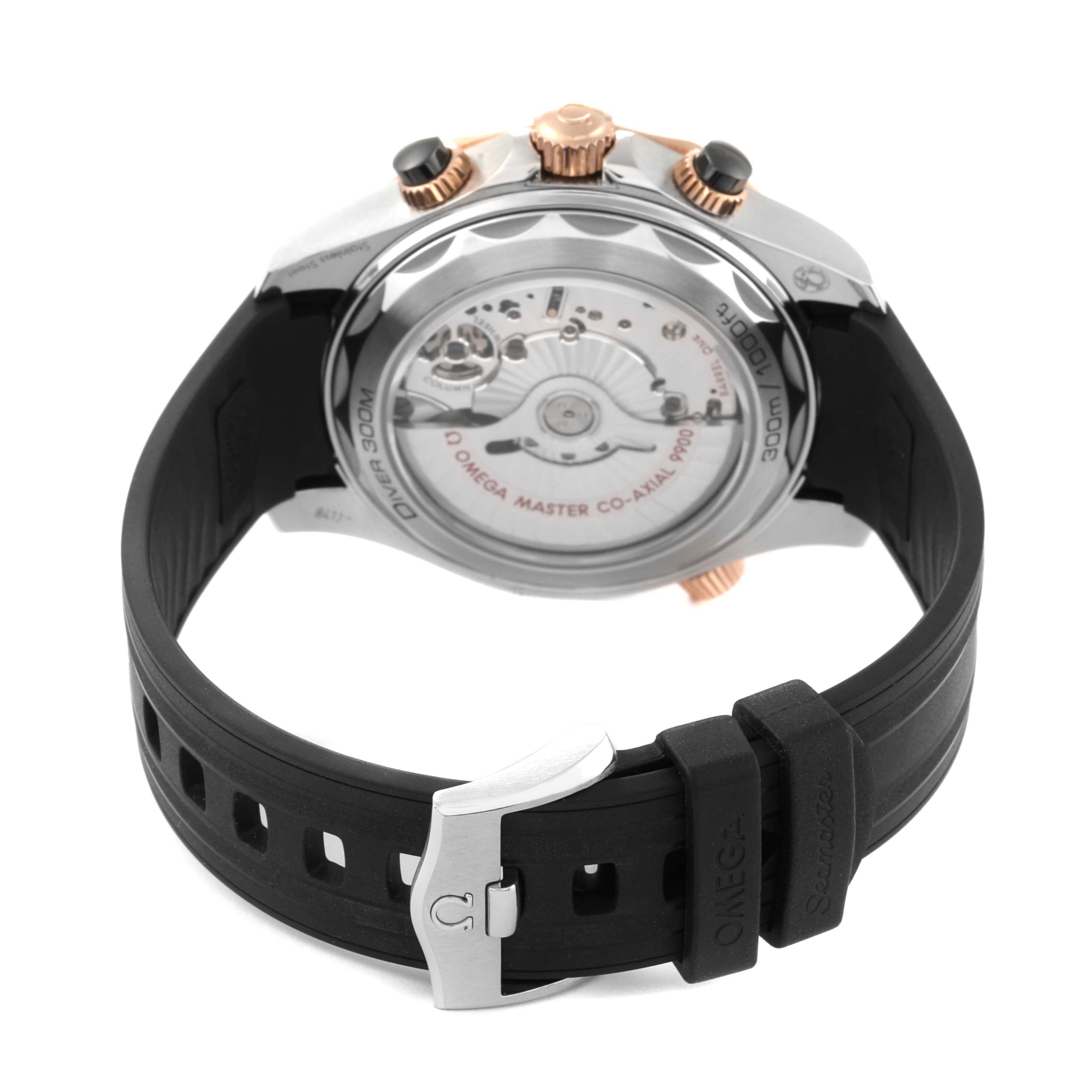 The image shows the back view of the Omega Seamaster 210.22.44.51.01.001 Men's Steel and Gold (two tone) Black Dial 210.22.44.51.01.001 Men's Steel and Gold (two tone) Black Dial watch, highlighting the movement and black rubber strap with the clasp.