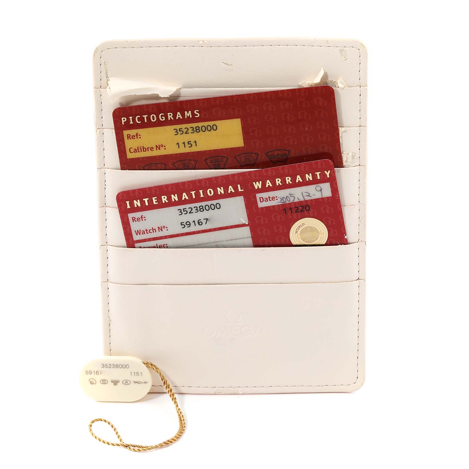 The image shows warranty and pictogram cards in a white cardholder for an Omega Speedmaster 3523.80.00 Men
s Stainless Steel Blue Dial 3523.80.00 Men
s Stainless Steel Blue Dial watch.