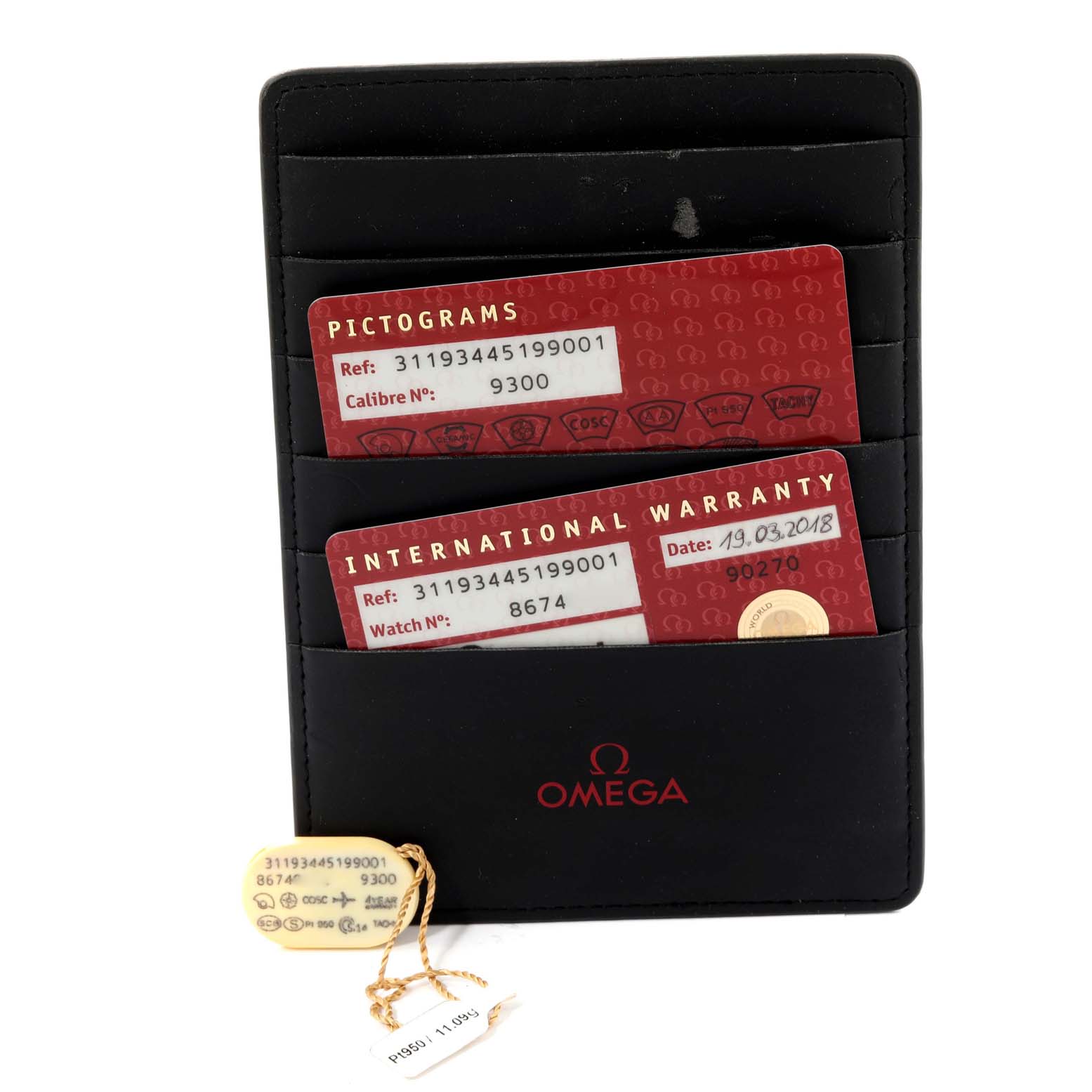 This image shows the warranty cards, pictogram card, and tag for an Omega Speedmaster 311.93.44.51.99.001 Men's Ceramic Silver Dial 311.93.44.51.99.001 Men's Ceramic Silver Dial watch placed in a black cardholder.