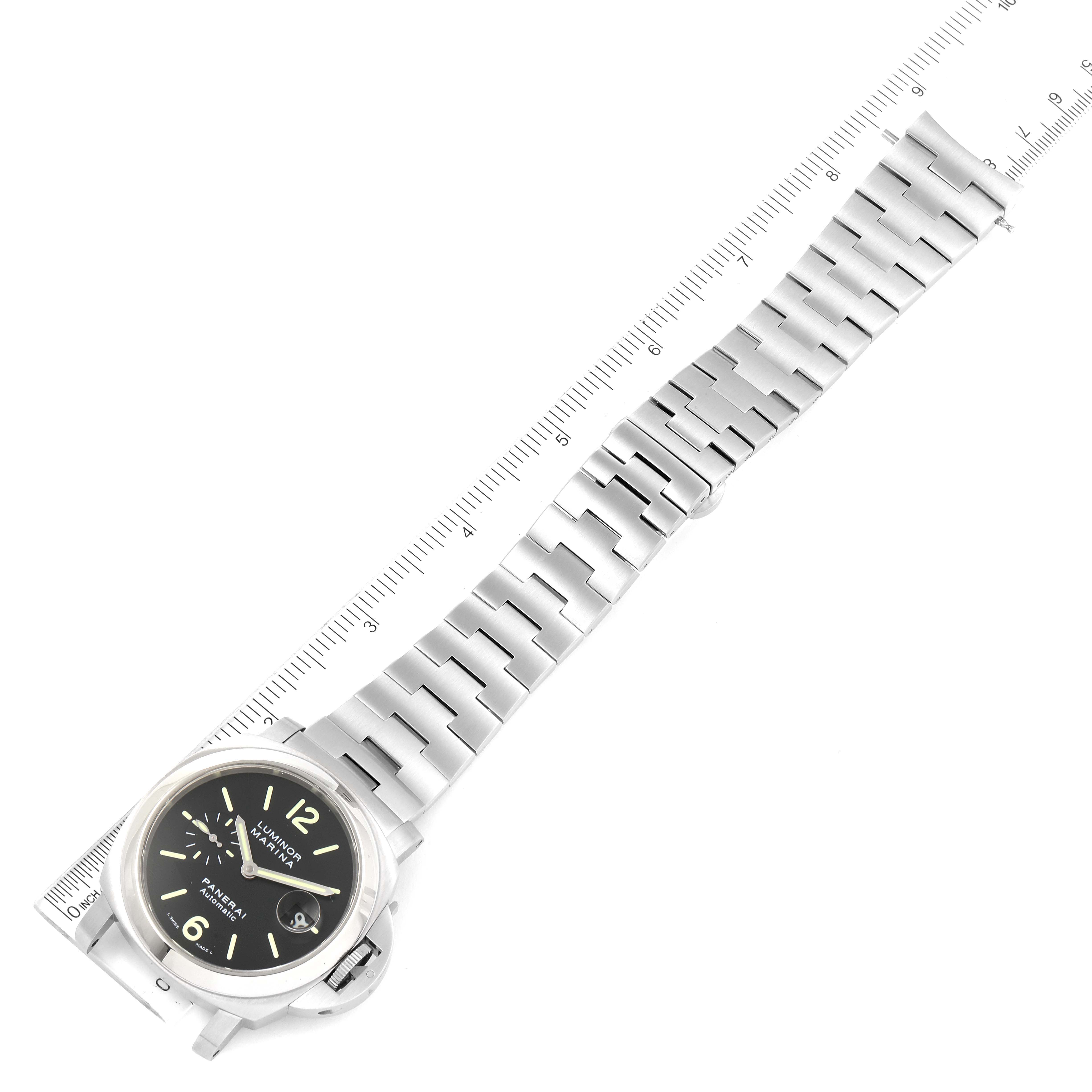 The image shows a top-down view of a Panerai Luminor PAM00299 Men's Stainless Steel Black Dial PAM00299 Men's Stainless Steel Black Dial model watch and its stainless steel bracelet against a ruler for scale.