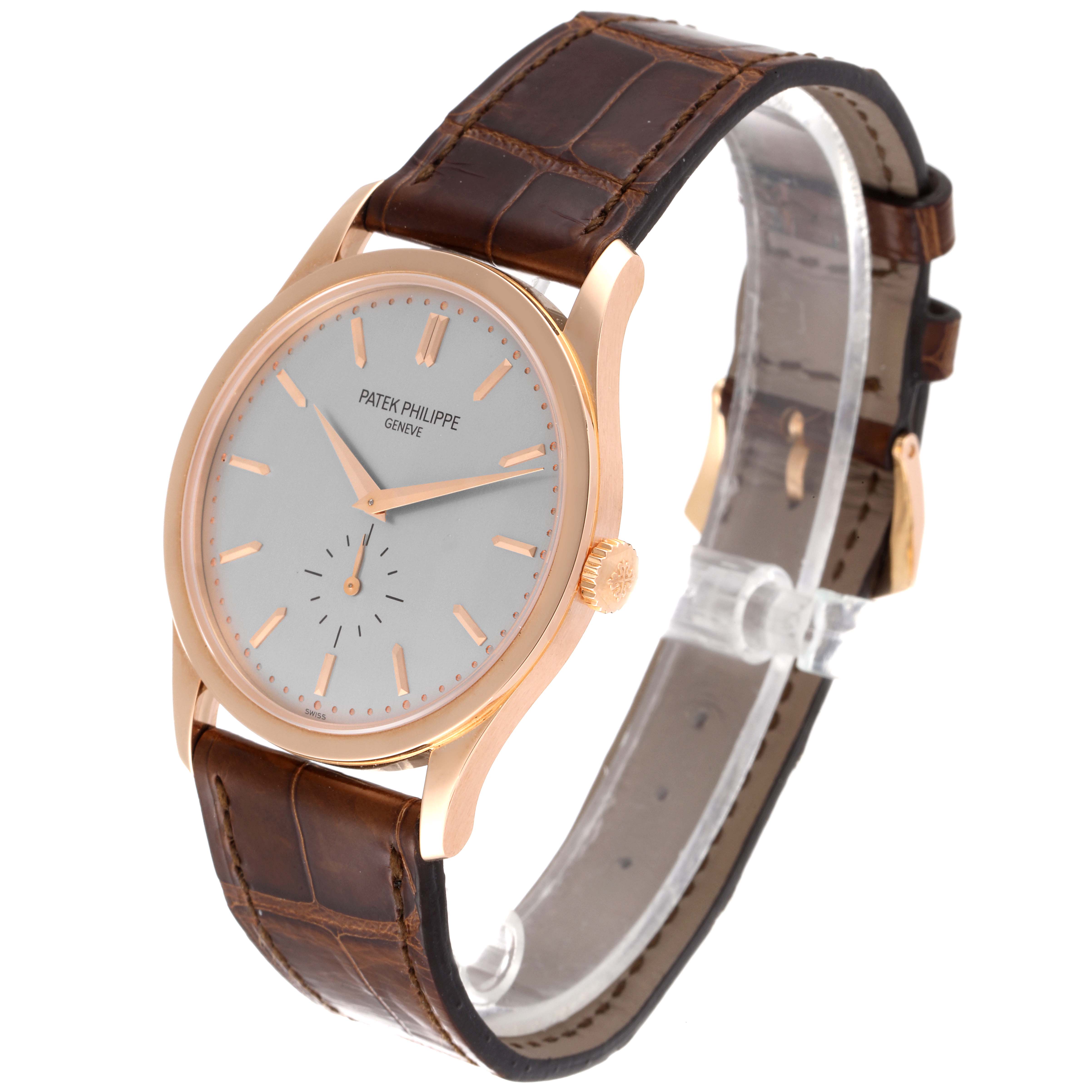 The Patek Philippe Calatrava 5196R Men
s Rose Gold Silver Dial 5196R Men
s Rose Gold Silver Dial watch is shown at a slight angle, highlighting its face, crown, and leather strap.