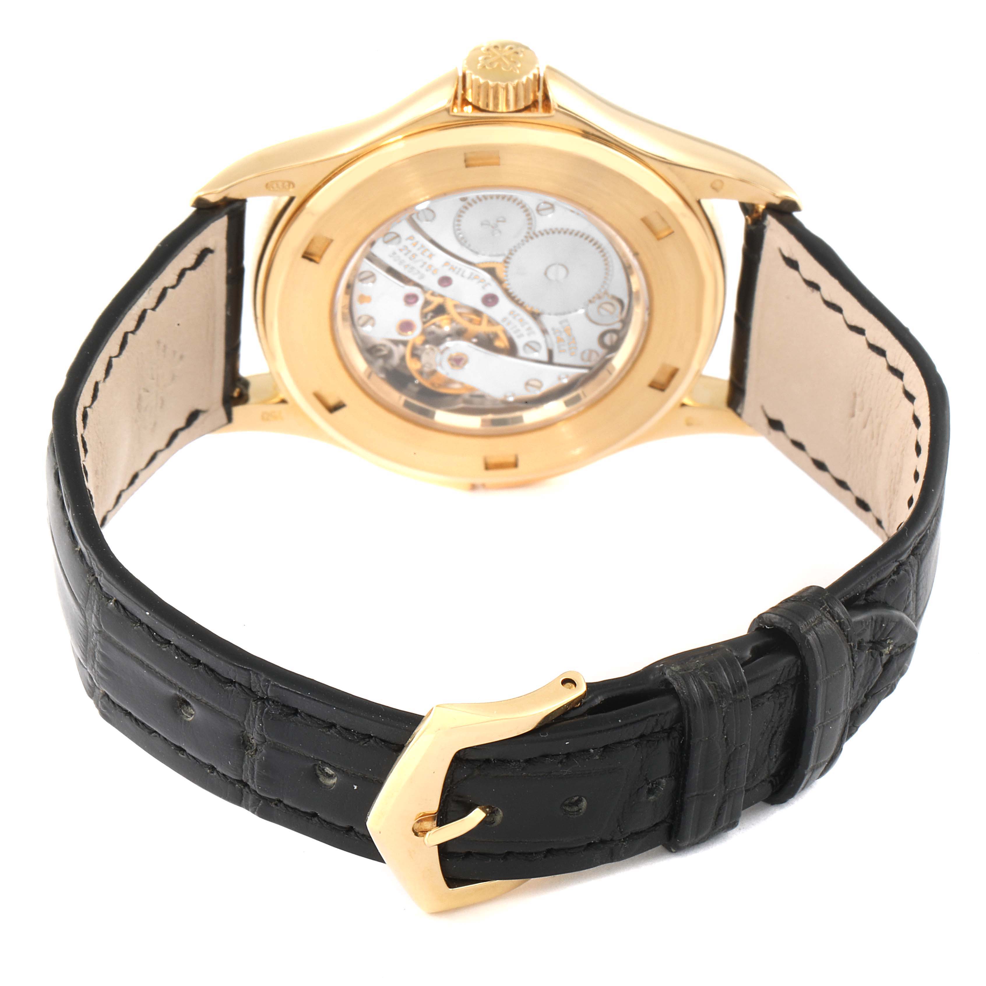 This image shows the back view of a Patek Philippe Calatrava 5134J Men's Yellow Gold White Dial 5134J Men's Yellow Gold White Dial watch, highlighting its movement and black leather strap.