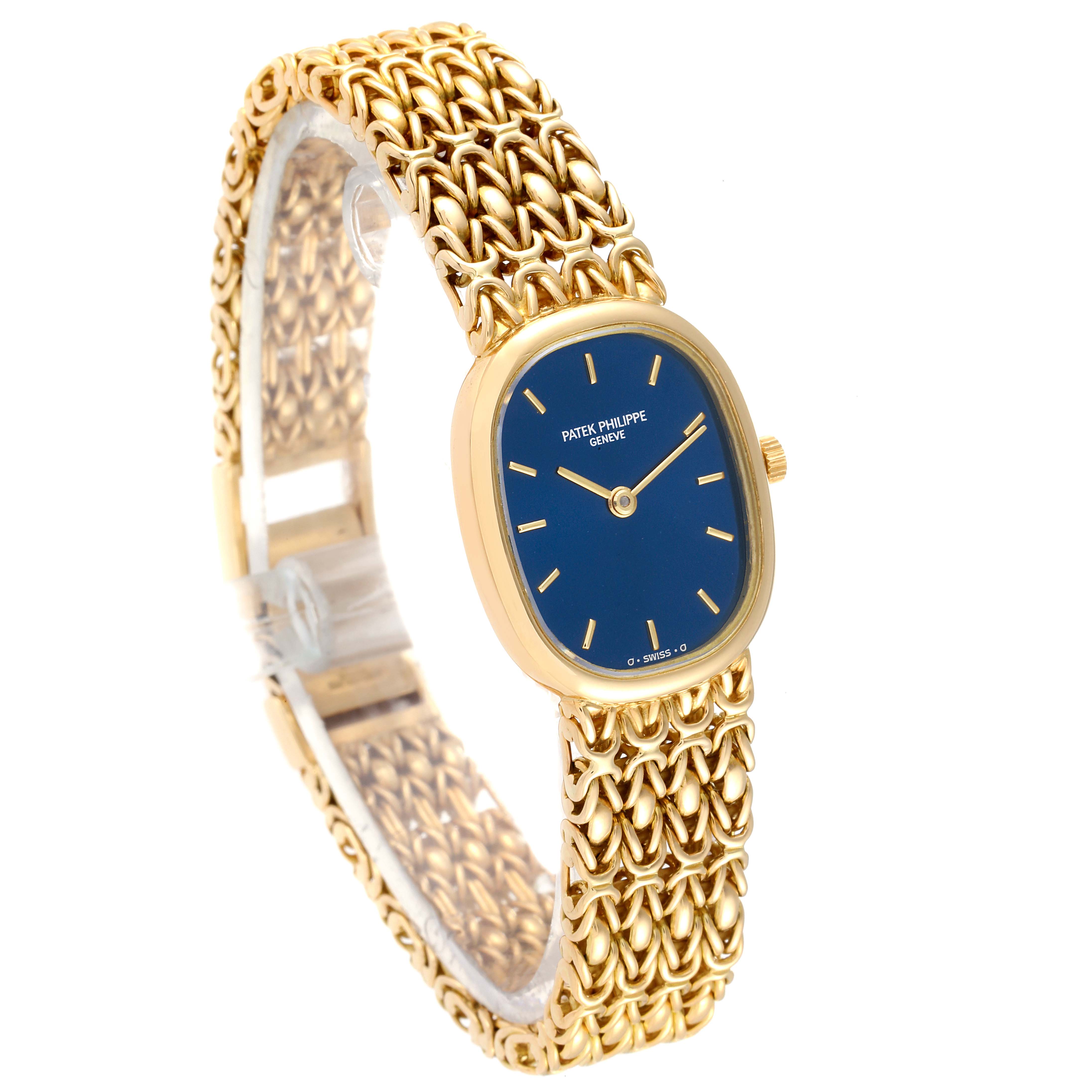 The image shows a Patek Philippe Golden Ellipse 4764 Women's Yellow Gold Blue Dial 4764 Women's Yellow Gold Blue Dial watch at a three-quarter angle, highlighting its blue dial and intricate gold bracelet.