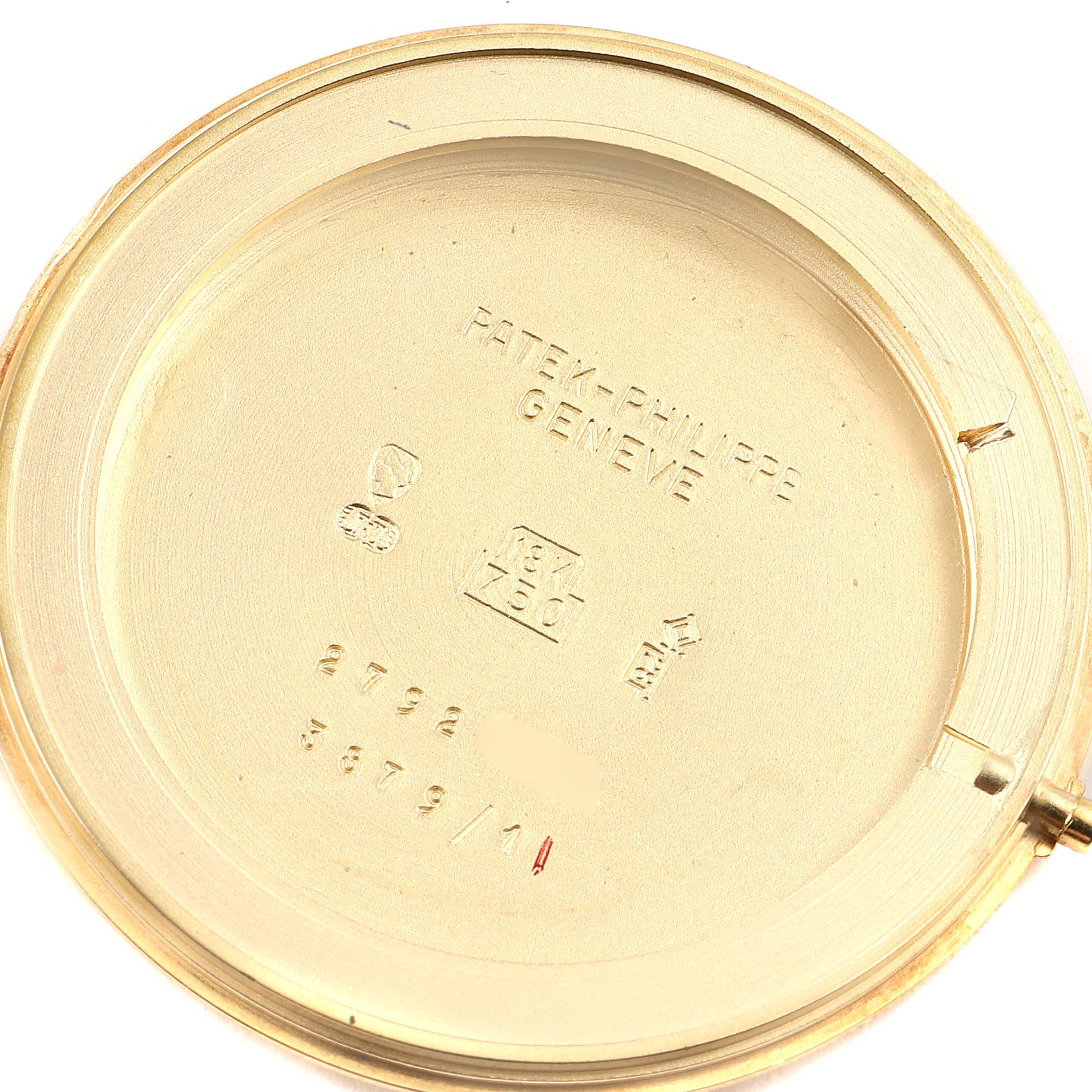 This image shows the interior case back of a Patek Philippe Golden Ellipse 3879 Men's Yellow Gold Silver Dial 3879 Men's Yellow Gold Silver Dial watch, revealing the brand engravings and serial numbers.