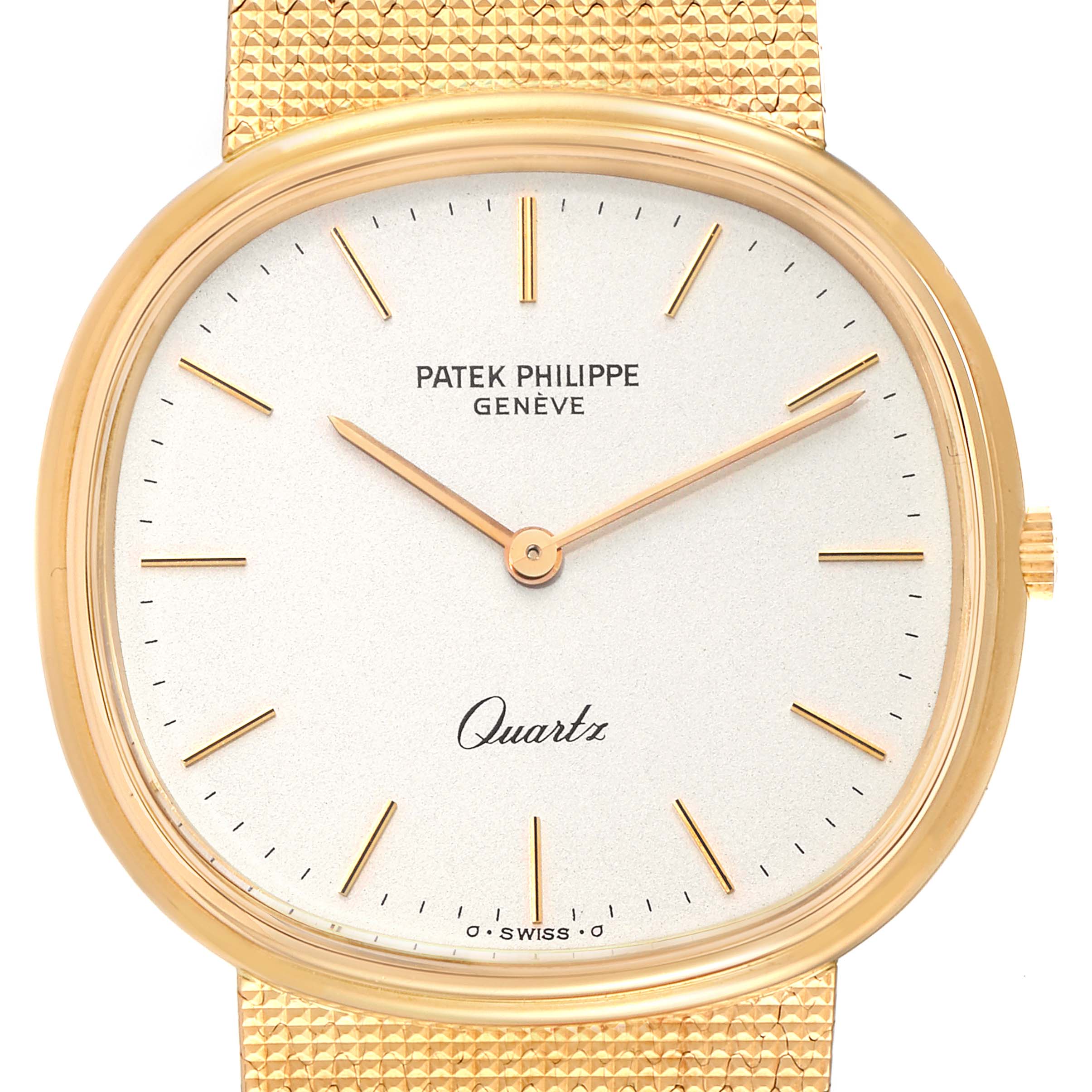 This image shows a close-up view of the Patek Philippe Golden Ellipse 3879 Men's Yellow Gold Silver Dial 3879 Men's Yellow Gold Silver Dial watch, highlighting its face and partial gold mesh strap.