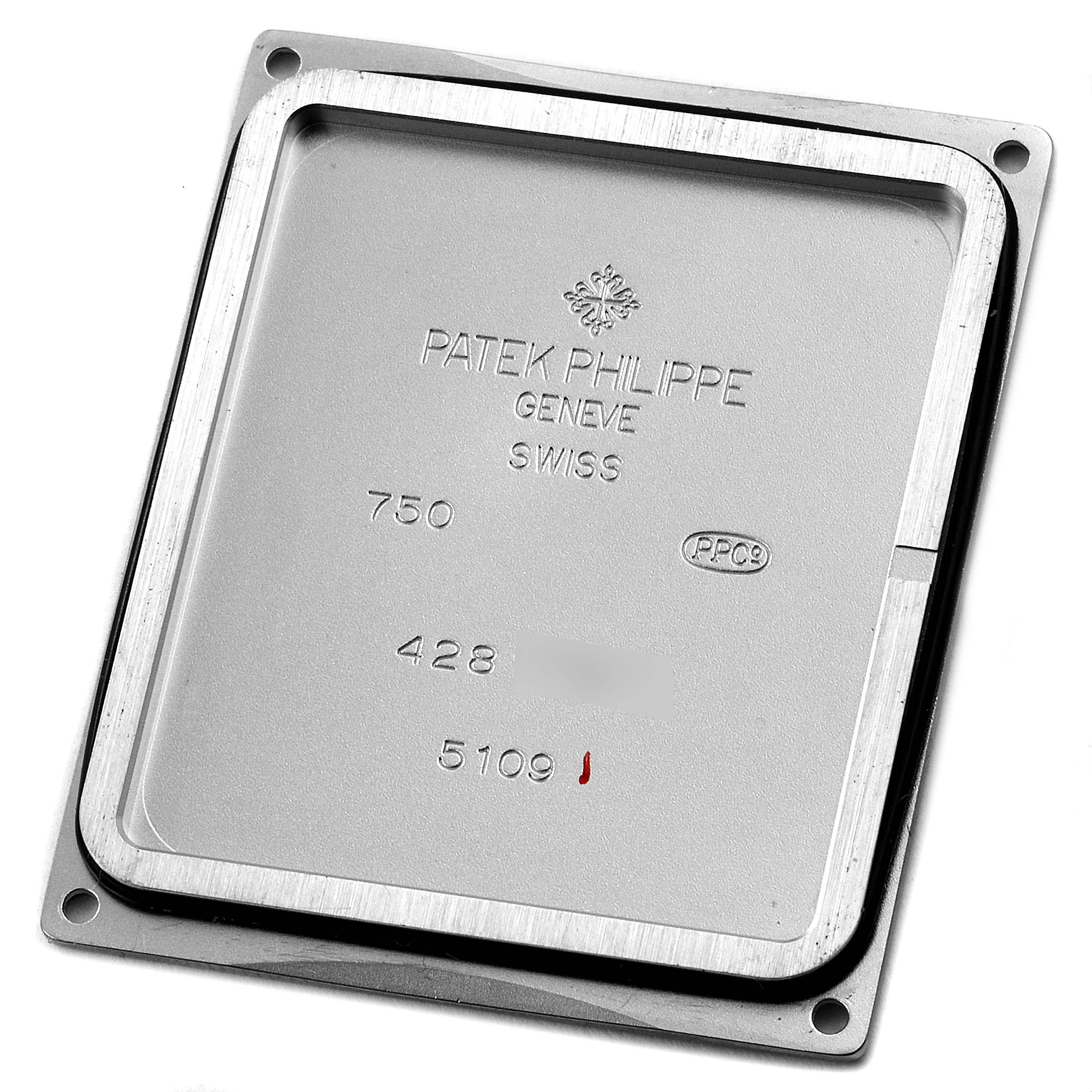 This image shows the backside case of a Patek Philippe Gondolo 5109G Men's White Gold Silver Dial 5109G Men's White Gold Silver Dial watch, photographed from the top down.