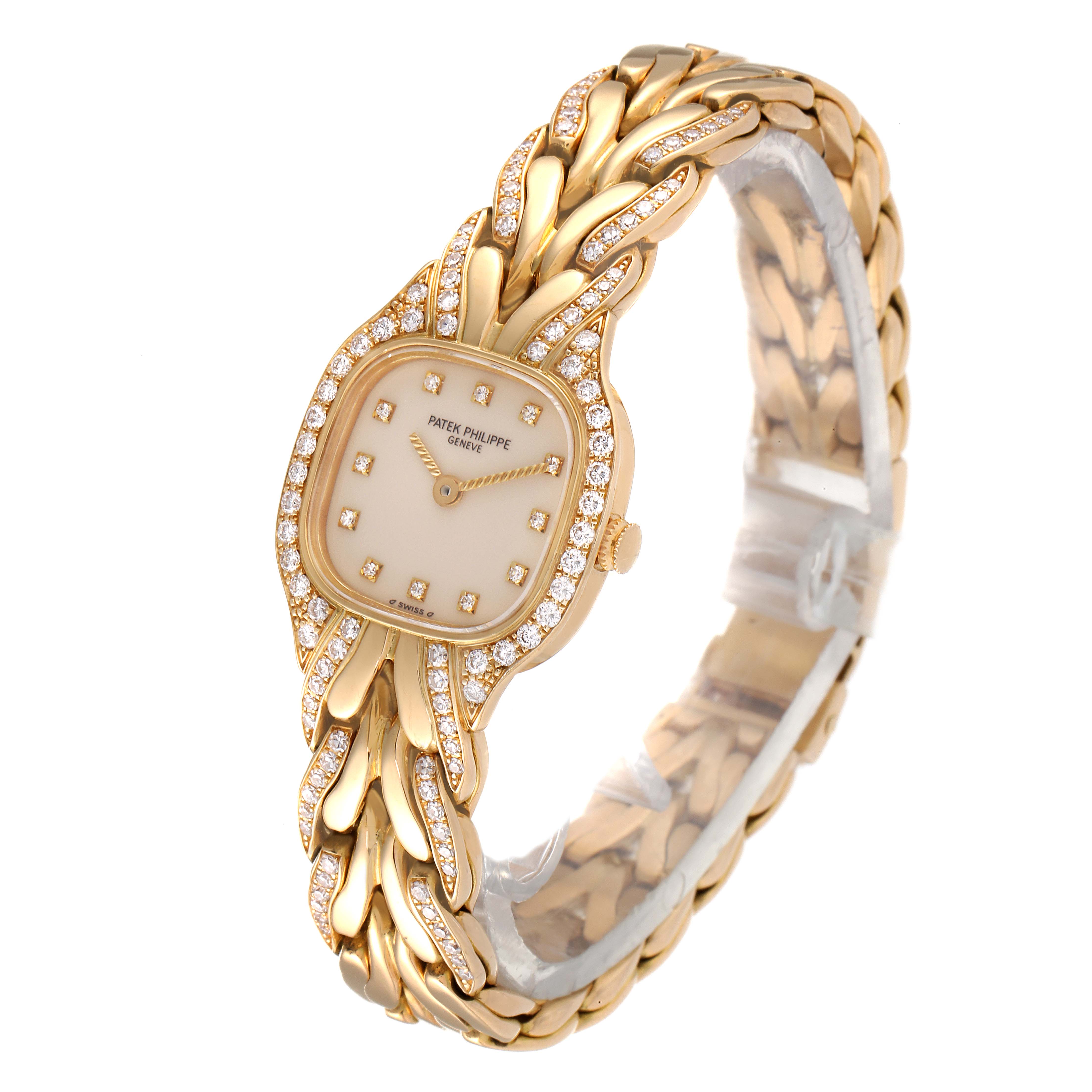 The Patek Philippe La Flamme  4715J Women's Yellow Gold Silver Dial 4715J Women's Yellow Gold Silver Dialwatch is shown at an angled view with focus on its ornate gold and diamond-encrusted design.