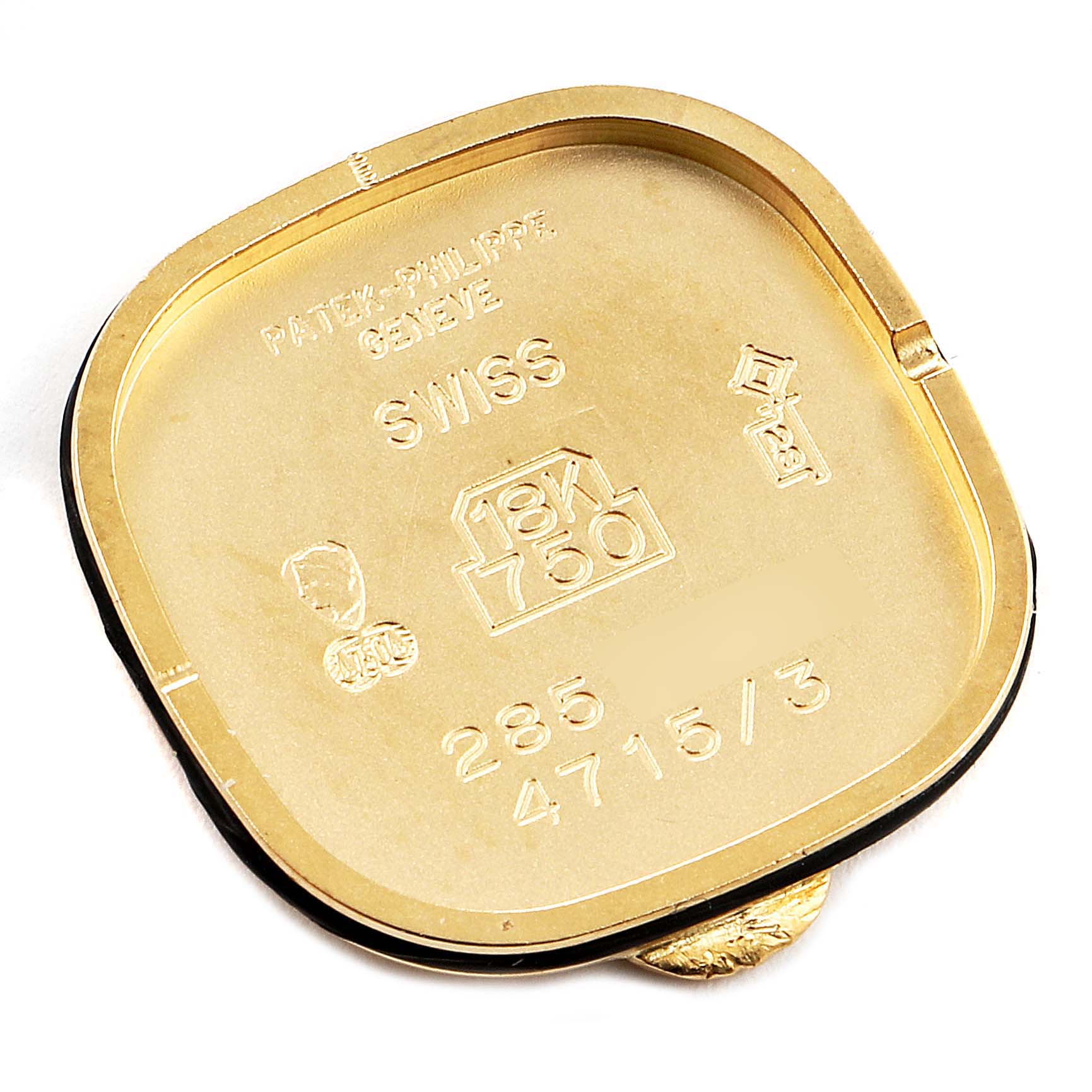 The image shows the case back of a La Flamme model by Patek Philippe, showcasing its internal markings and gold content.