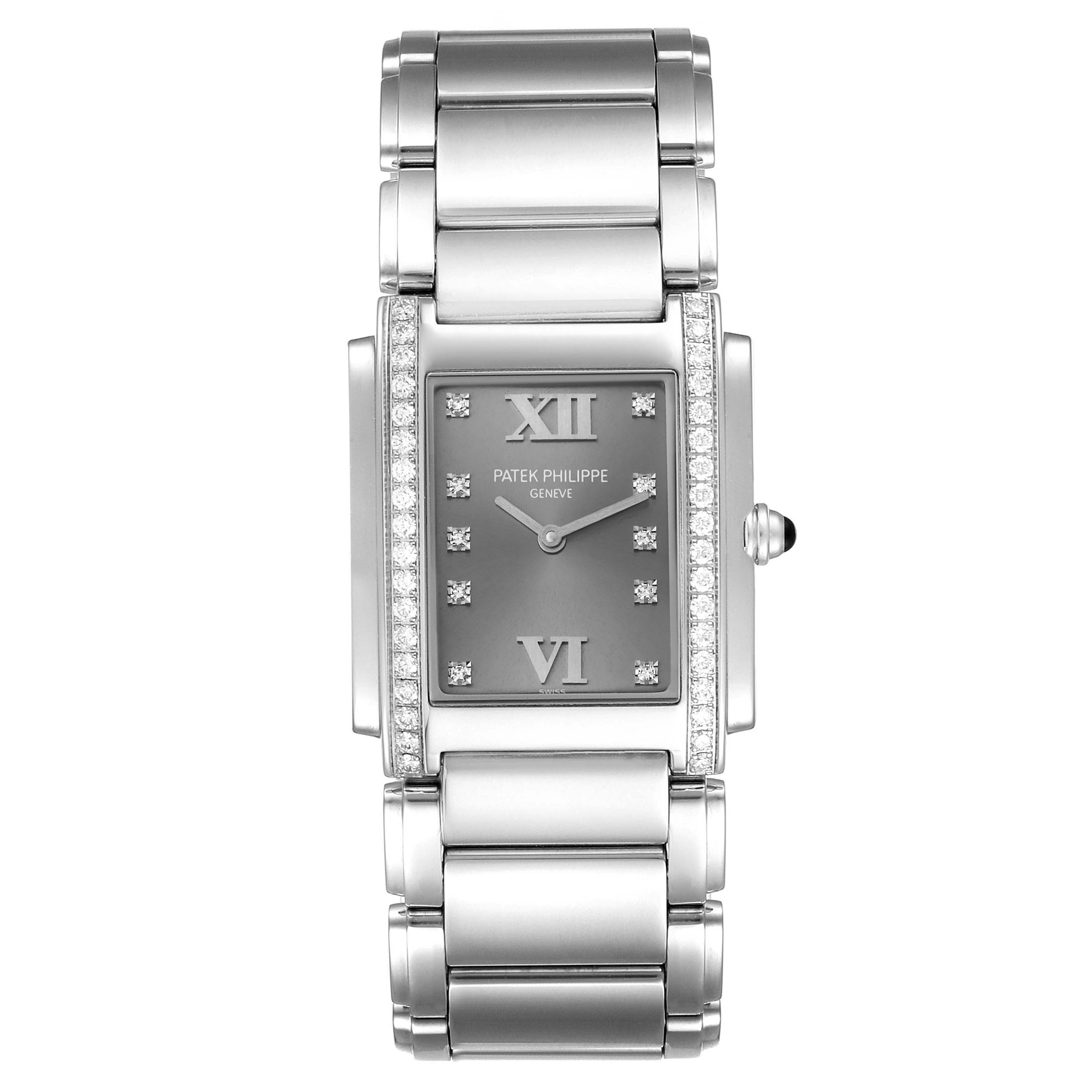 The image shows a front view of the Patek Philippe Twenty-4 4910/10A-010 Women's Stainless Steel Grey Dial 4910/10A-010 Women's Stainless Steel Grey Dial watch, highlighting its rectangular face, diamond accents, and metal bracelet.