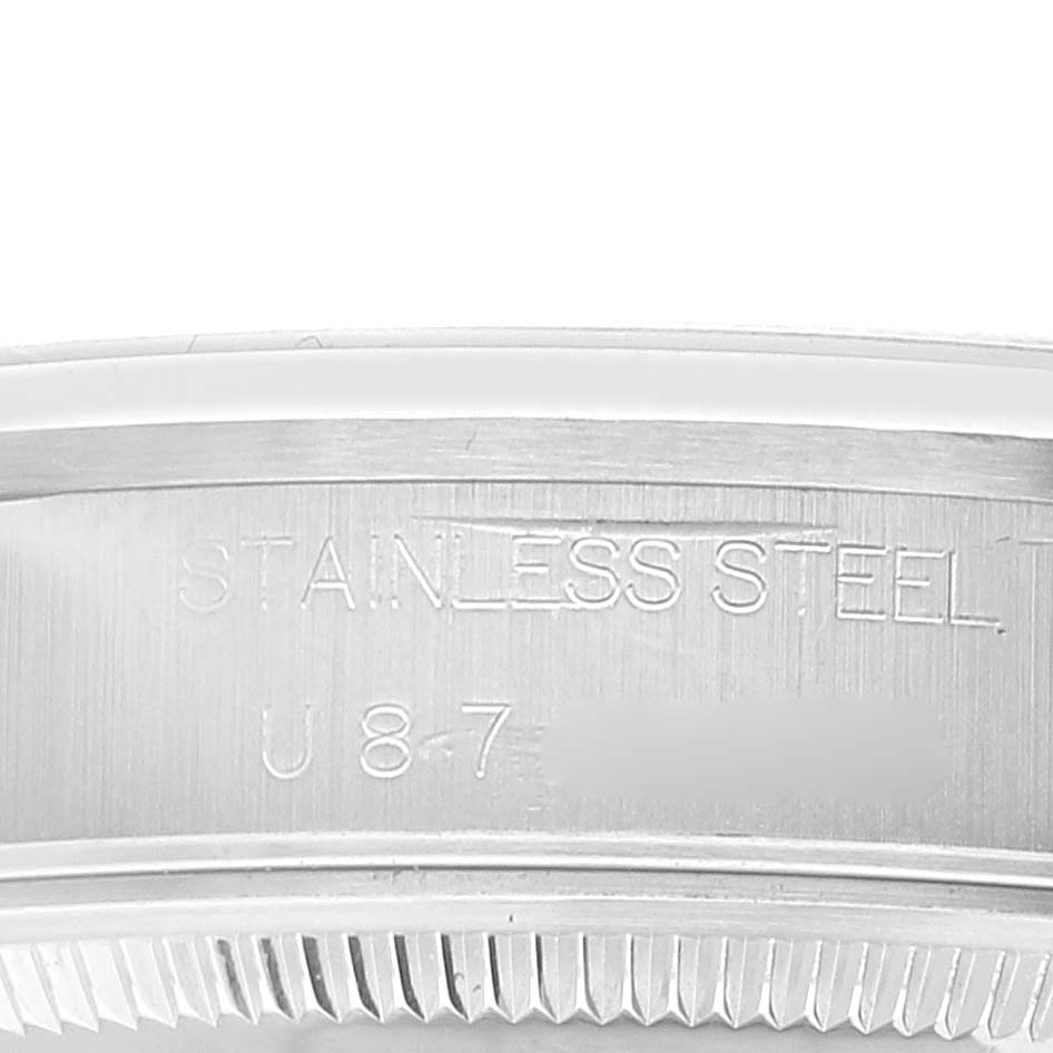 This is a close-up of the side of a stainless steel Rolex Air-King 14000 Men's Stainless Steel Black Dial 14000 Men's Stainless Steel Black Dial watch case, showing engraved text and part of the bezel.