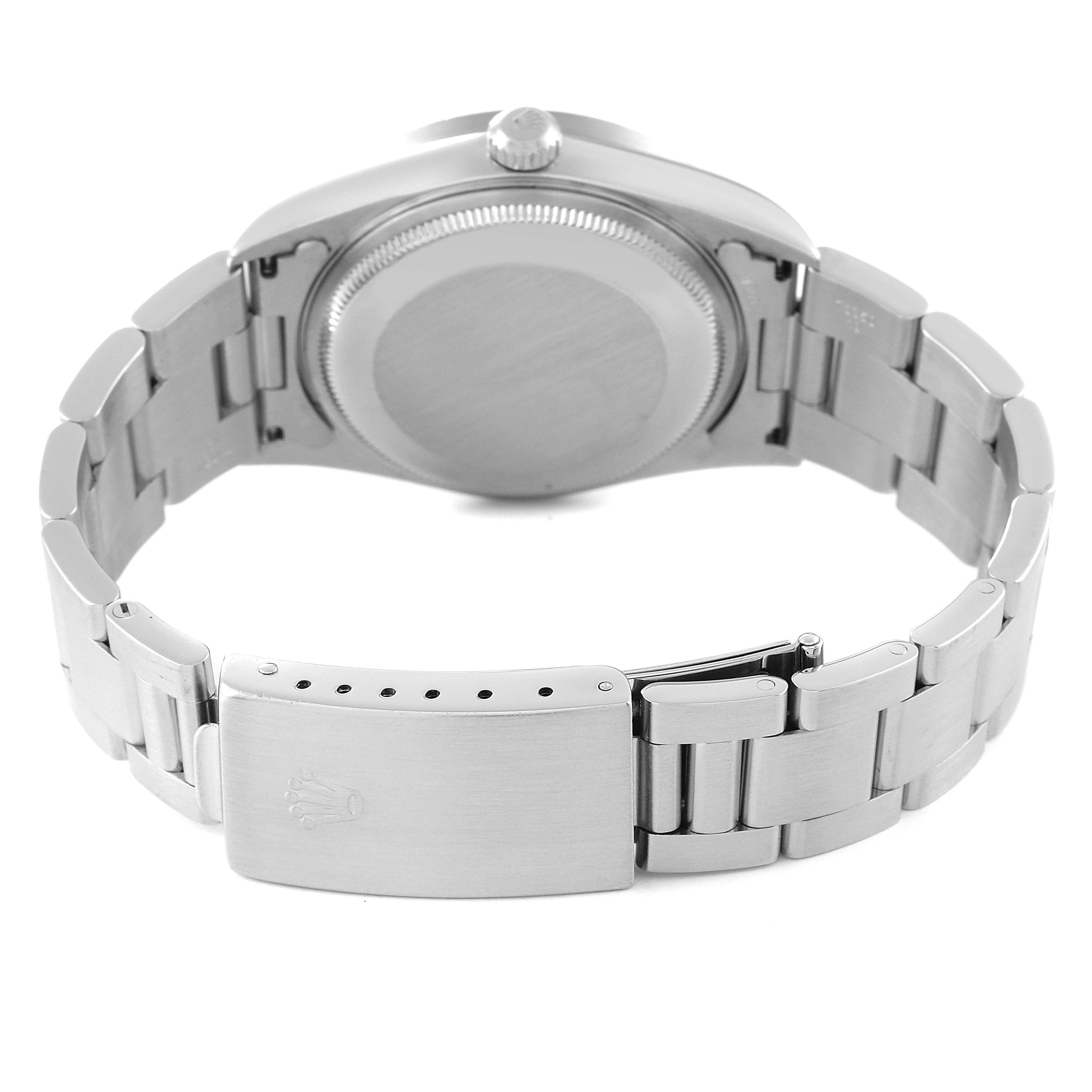 The Rolex Air-King 14010 Men's Stainless Steel Silver Dial 14010 Men's Stainless Steel Silver Dial watch is shown from the back, displaying its stainless steel case back, bracelet, and clasp.