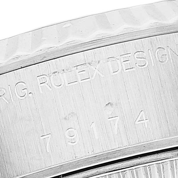 The image shows a close-up of the inner bezel of a Rolex Datejust 79174 Women's Stainless Steel Silver Dial 79174 Women's Stainless Steel Silver Dial watch featuring engraved text.