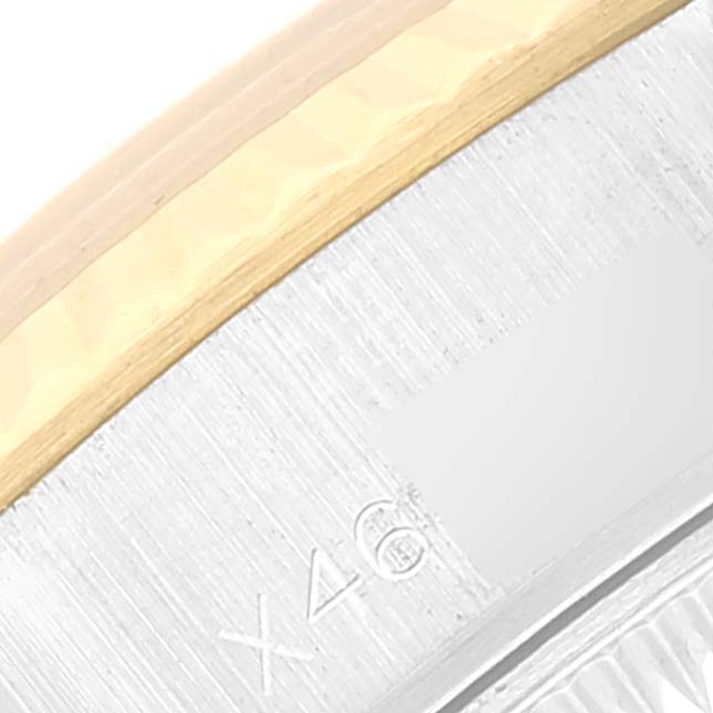 This close-up image of a Rolex Datejust 69173 Women's Steel and Gold (two tone) White Dial 69173 Women's Steel and Gold (two tone) White Dial watch shows part of the bezel and case.