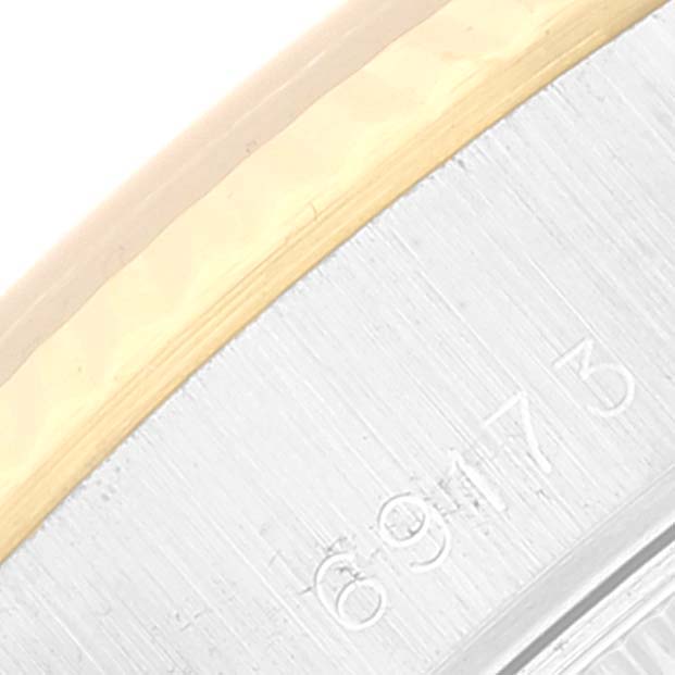This close-up image shows the partial bezel and case edge with markings of a Rolex Datejust 69173 Women's Steel and Gold (two tone) White Dial 69173 Women's Steel and Gold (two tone) White Dial watch.