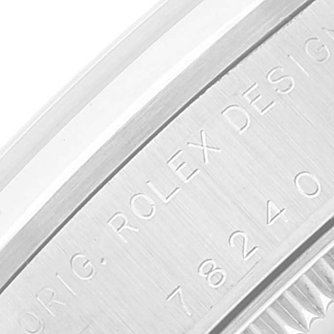 This close-up angle shows the engraved side detailing and model number on the Mid-Size Rolex watch.