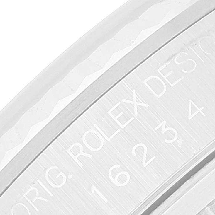 The image shows a close-up view of the engraved inner bezel and part of the dial of a Rolex Datejust 16234 Men's Stainless Steel Silver Dial 16234 Men's Stainless Steel Silver Dial watch.