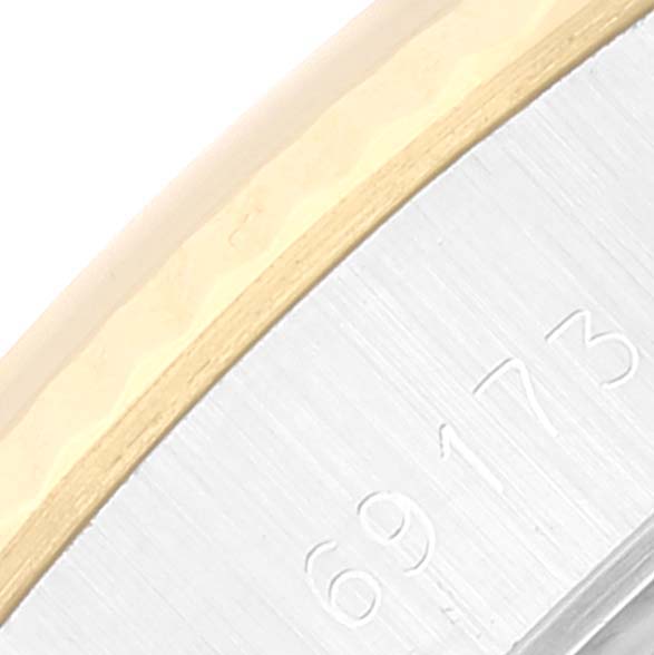 The image shows a close-up angle of a Rolex Datejust 69173 Women's Steel and Gold (two tone) Champagne Dial 69173 Women's Steel and Gold (two tone) Champagne Dial model watch, focusing on a portion of the case with visible serial numbers.