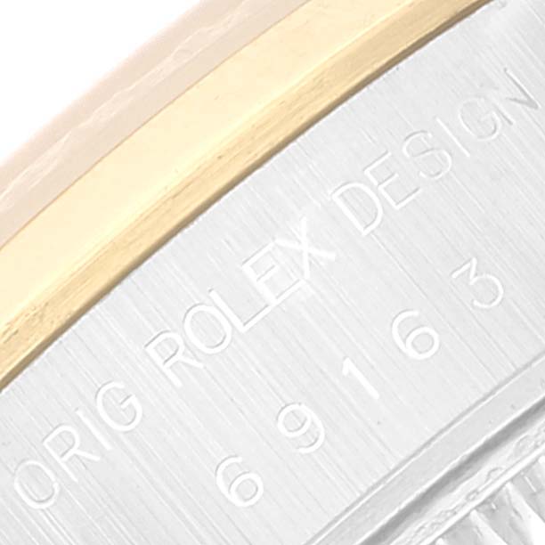 This is a close-up of the side of the Rolex Datejust 69163 Women's Steel and Gold (two tone) Champagne Dial 69163 Women's Steel and Gold (two tone) Champagne Dial, showing the "ROLEX DESIGN" engraving.