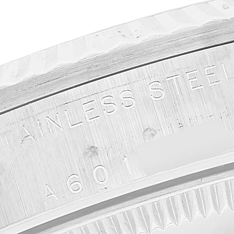 The image shows a close-up of the stainless steel bezel and inner case markings of a Mid-Size Rolex watch.