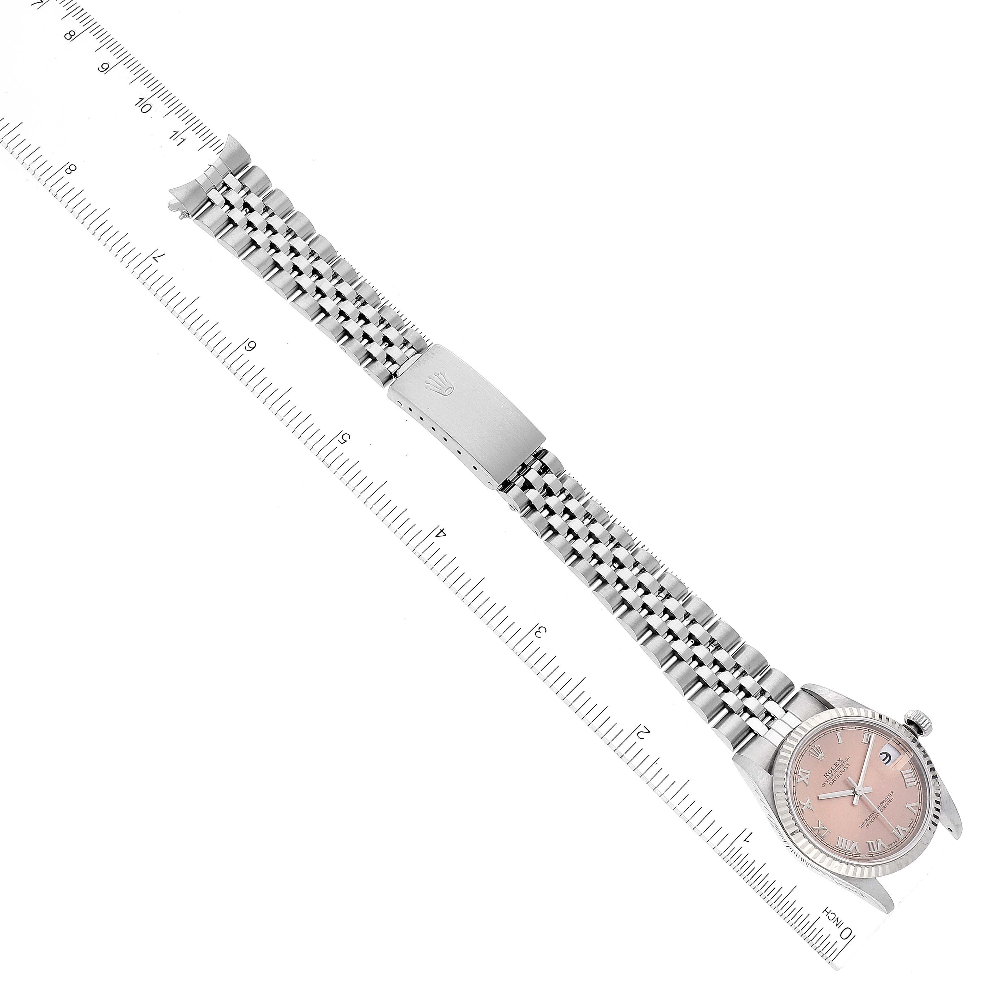 The image shows a Rolex Mid-Size 78274 Women's Stainless Steel Pink Dial 78274 Women's Stainless Steel Pink Dial watch from a top-down angle, displaying its stainless steel band, clasp, and pink dial.