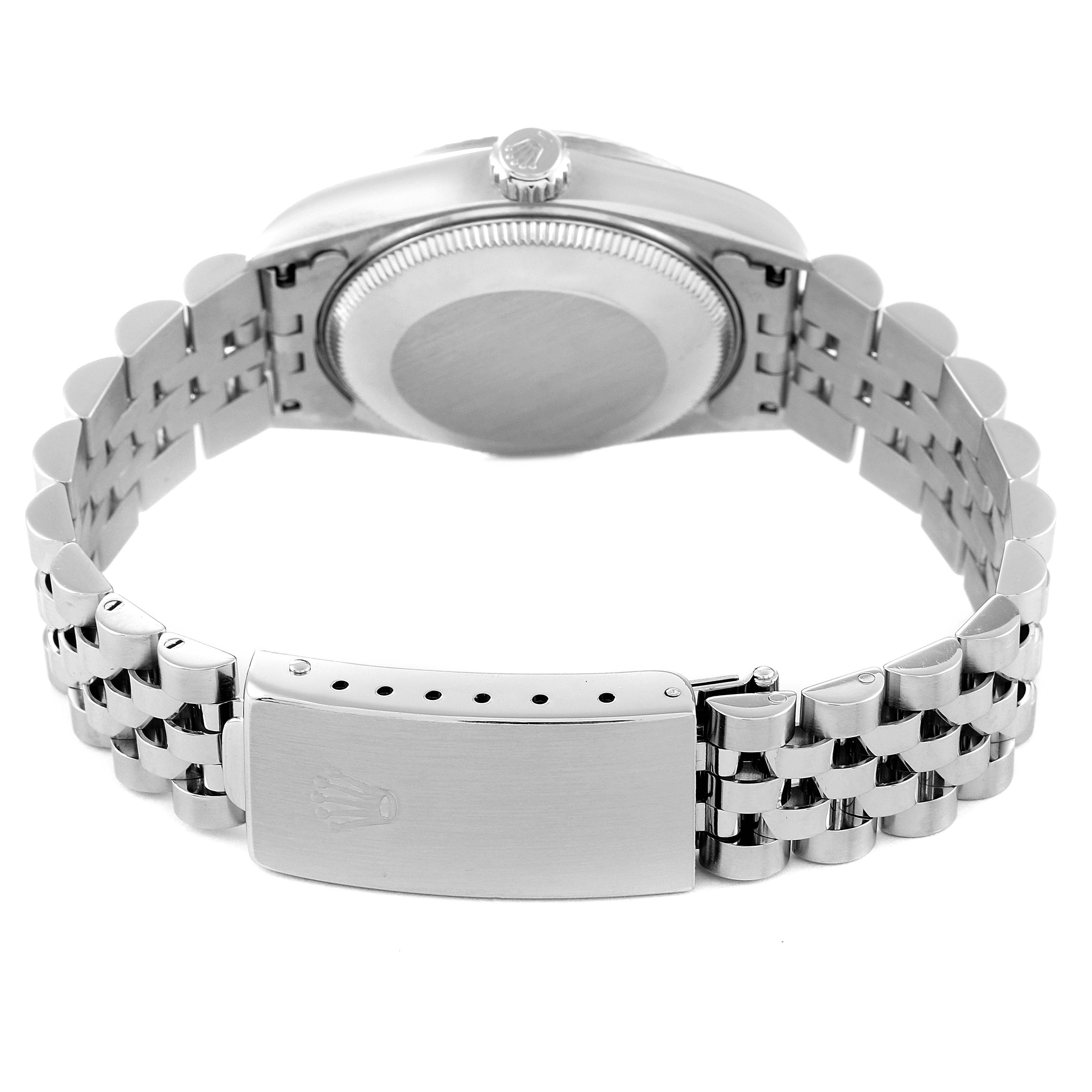 The image shows the back and clasp of a Mid-Size Rolex watch, focusing on the metal bracelet and case back.