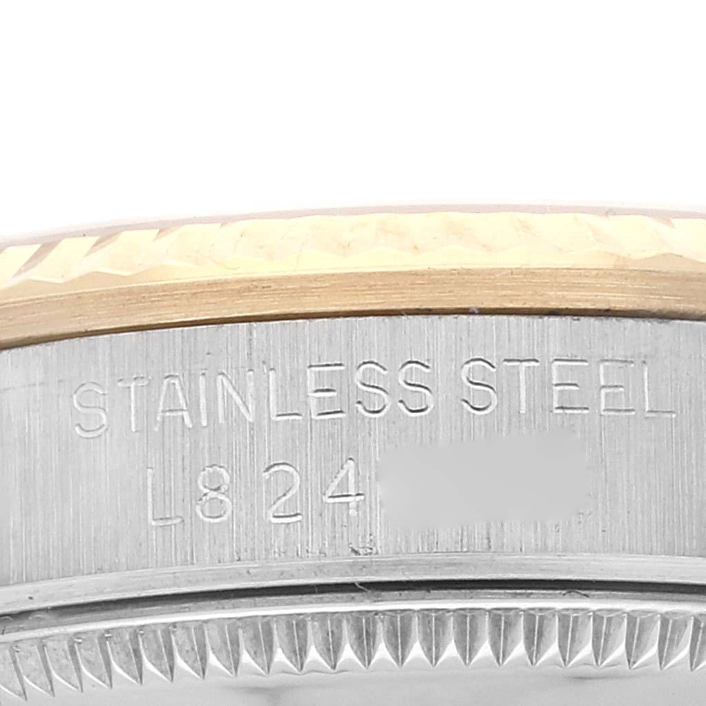 This close-up image of a mid-size Rolex watch shows the stainless steel casing and part of the bezel.