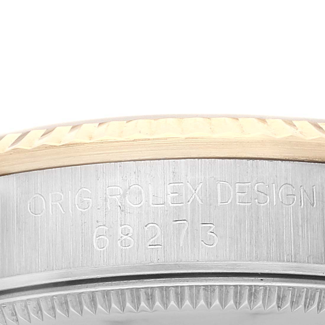 The image shows a close-up of the case side and bezel of a Rolex Mid-Size 68273 Women
s Steel and Gold (two tone) Champagne Dial 68273 Women
s Steel and Gold (two tone) Champagne Dial model, displaying the engraved model number 68273.