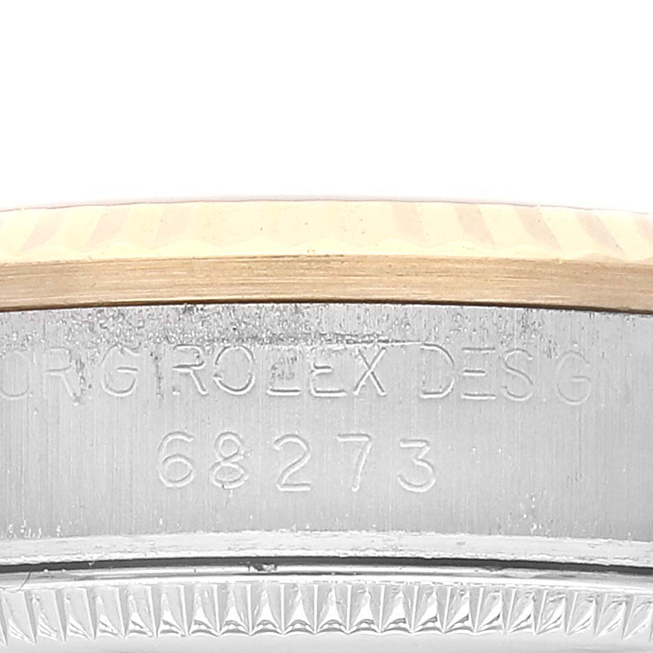 The image shows a close-up of the case side and bezel of a Rolex Mid-Size 68273 Women's Steel and Gold (two tone) Silver Dial 68273 Women's Steel and Gold (two tone) Silver Dial model watch with the model number 68273 engraved.