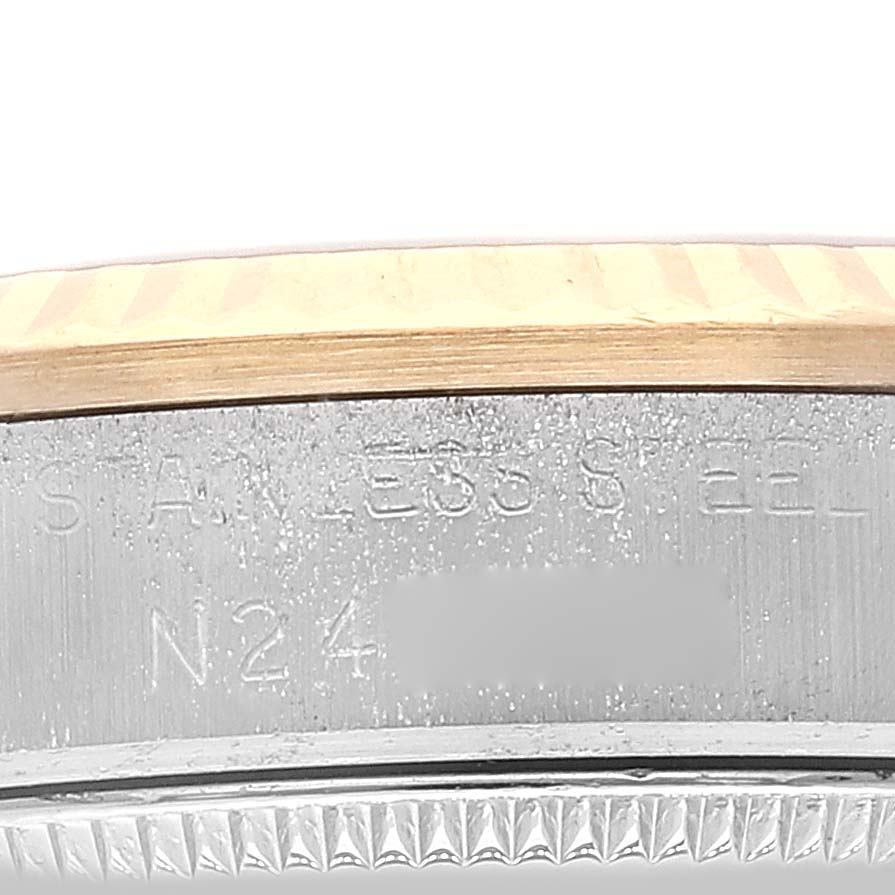 The close-up image of the Rolex Mid-Size 68273 Women's Steel and Gold (two tone) Silver Dial 68273 Women's Steel and Gold (two tone) Silver Dial watch shows the engraved bezel and parts of the case.