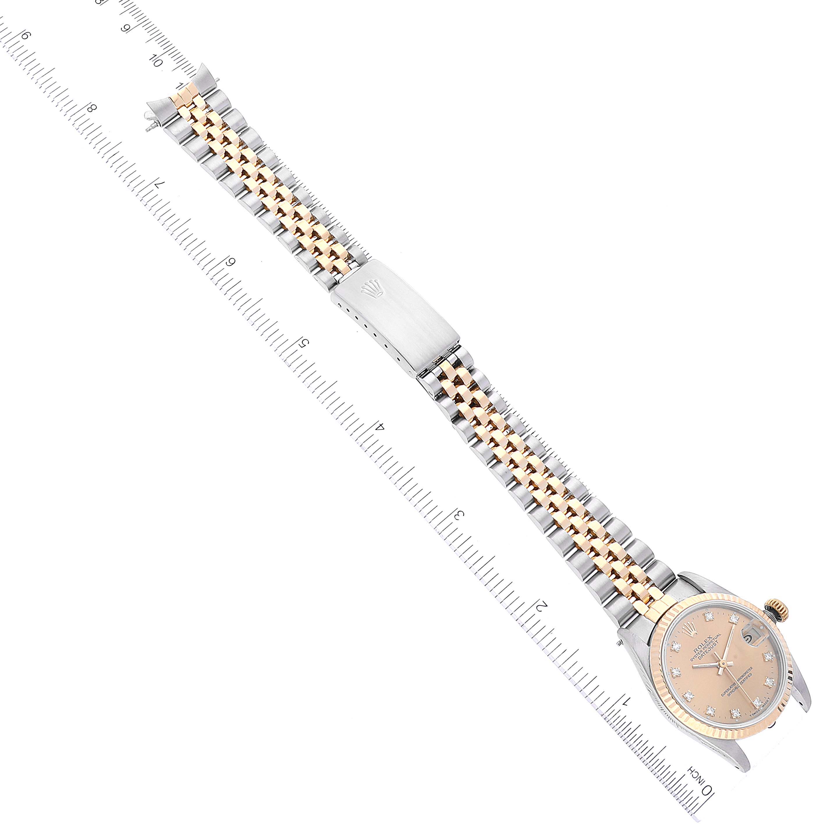The image shows a top-down view of a Rolex Mid-Size 68273 Women
s Steel and Gold (two tone) Champagne Dial 68273 Women
s Steel and Gold (two tone) Champagne Dial watch, highlighting its dial, bracelet, and clasp.