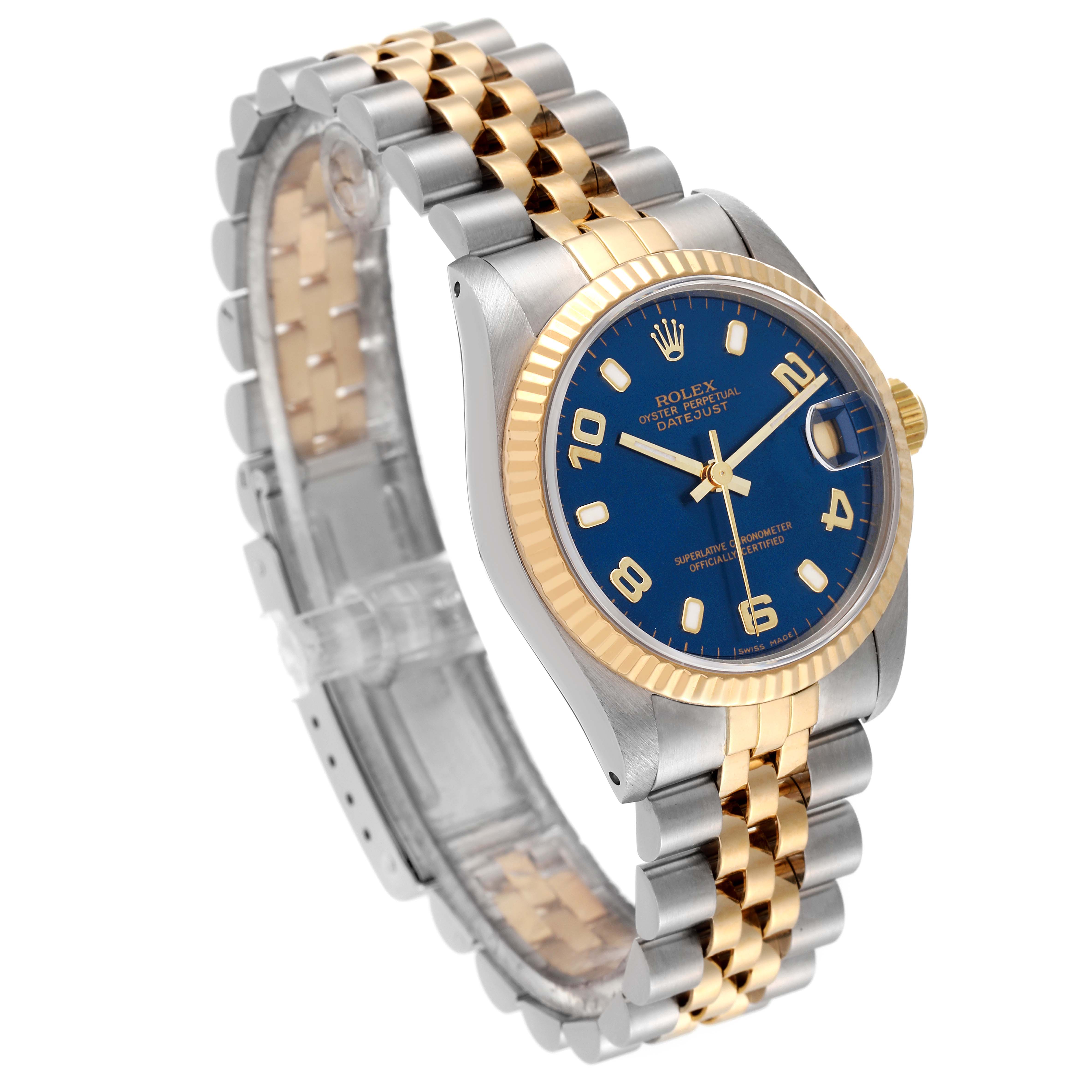 This image displays a Rolex Mid-Size 68273 Women's Steel and Gold (two tone) Blue Dial 68273 Women's Steel and Gold (two tone) Blue Dial watch at a slight angle, showcasing its blue dial, two-tone bracelet, and fluted bezel.