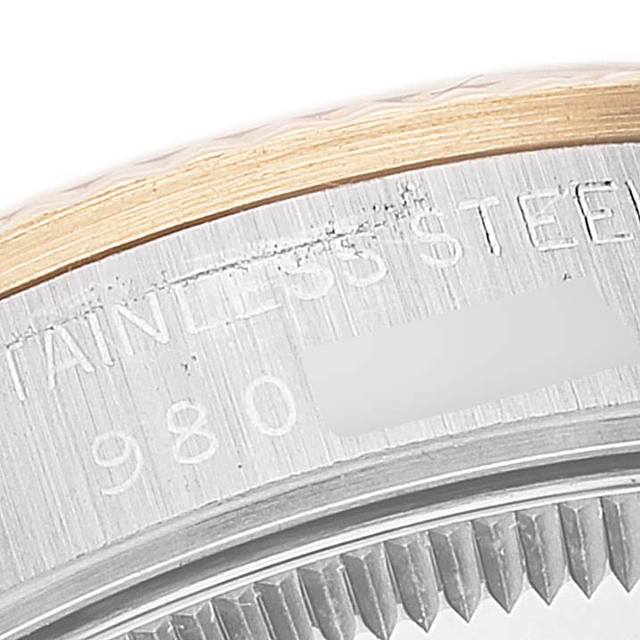 This image shows a close-up of the bezel and case back of a Mid-Size Rolex watch.