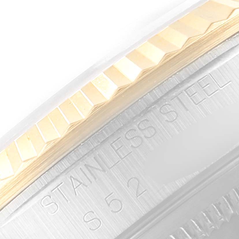 The image shows a close-up of the fluted bezel and part of the case back of a Rolex Datejust 16233 Men
s Steel and Gold (two tone) Grey Dial 16233 Men
s Steel and Gold (two tone) Grey Dial watch in stainless steel and gold.
